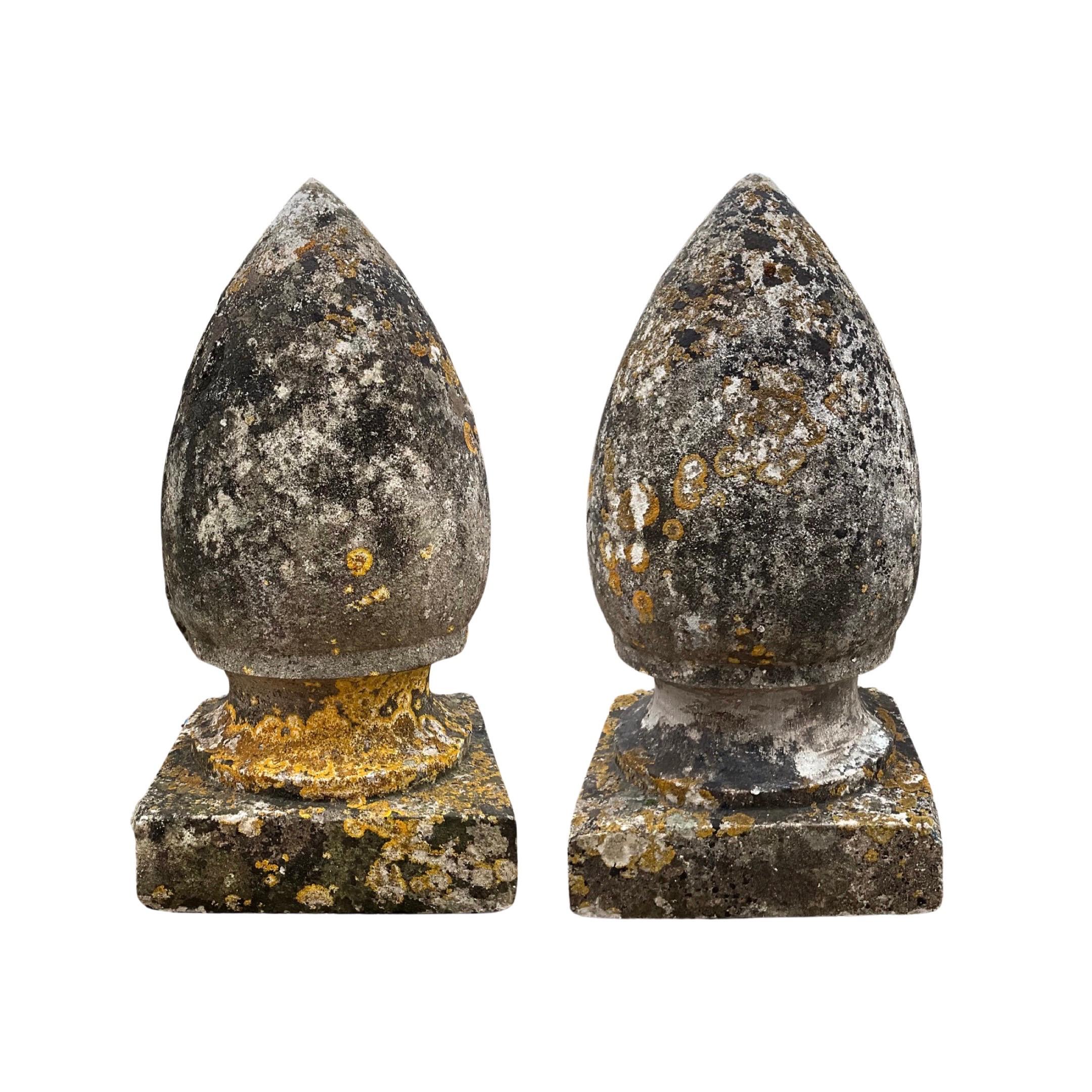 This pair of antique French limestone finials dates back to the 17th century and features a natural patina throughout. Made in France, these finials add a touch of history and elegance to any space they adorn. Enhance your decor with these expertly