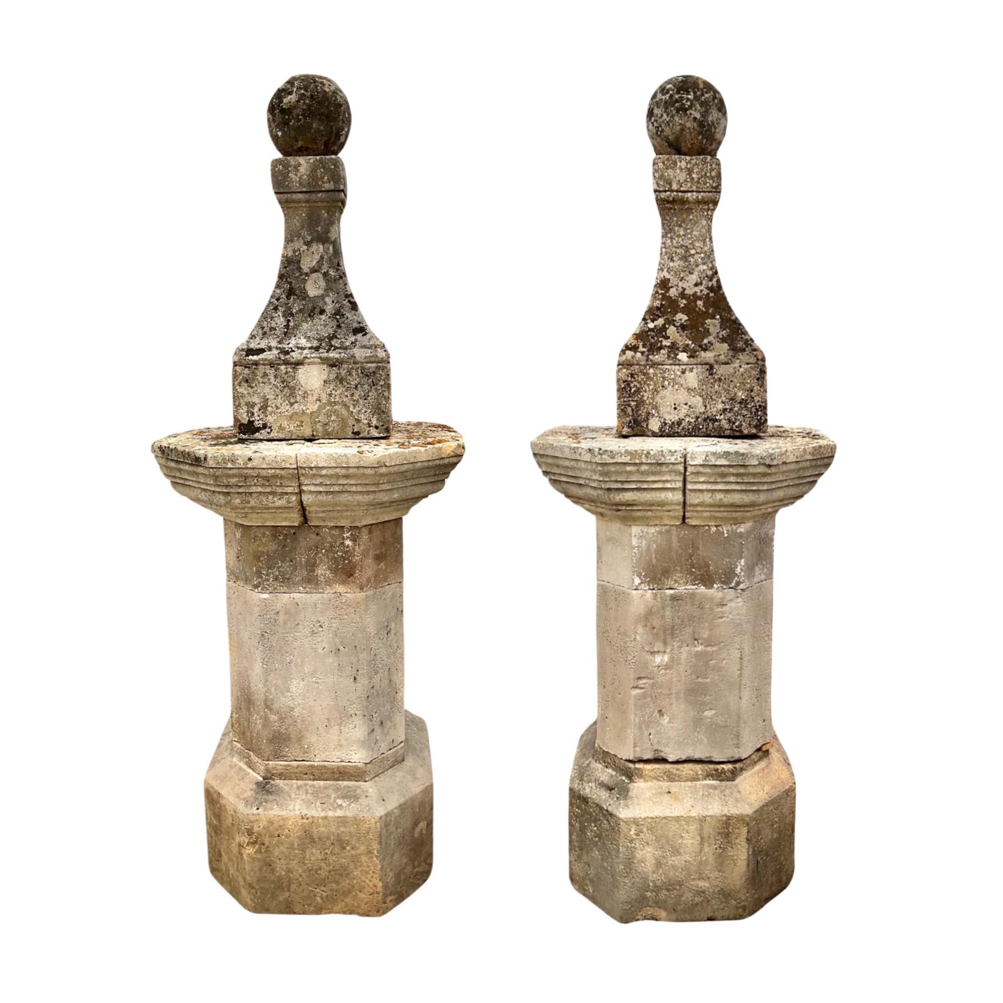Enhance your home or garden with this antique pair of French limestone finials. Crafted in the 17th century and sold as a set, these large style finials will add a touch of French elegance to any space. Perfect for architectural or decorative use.