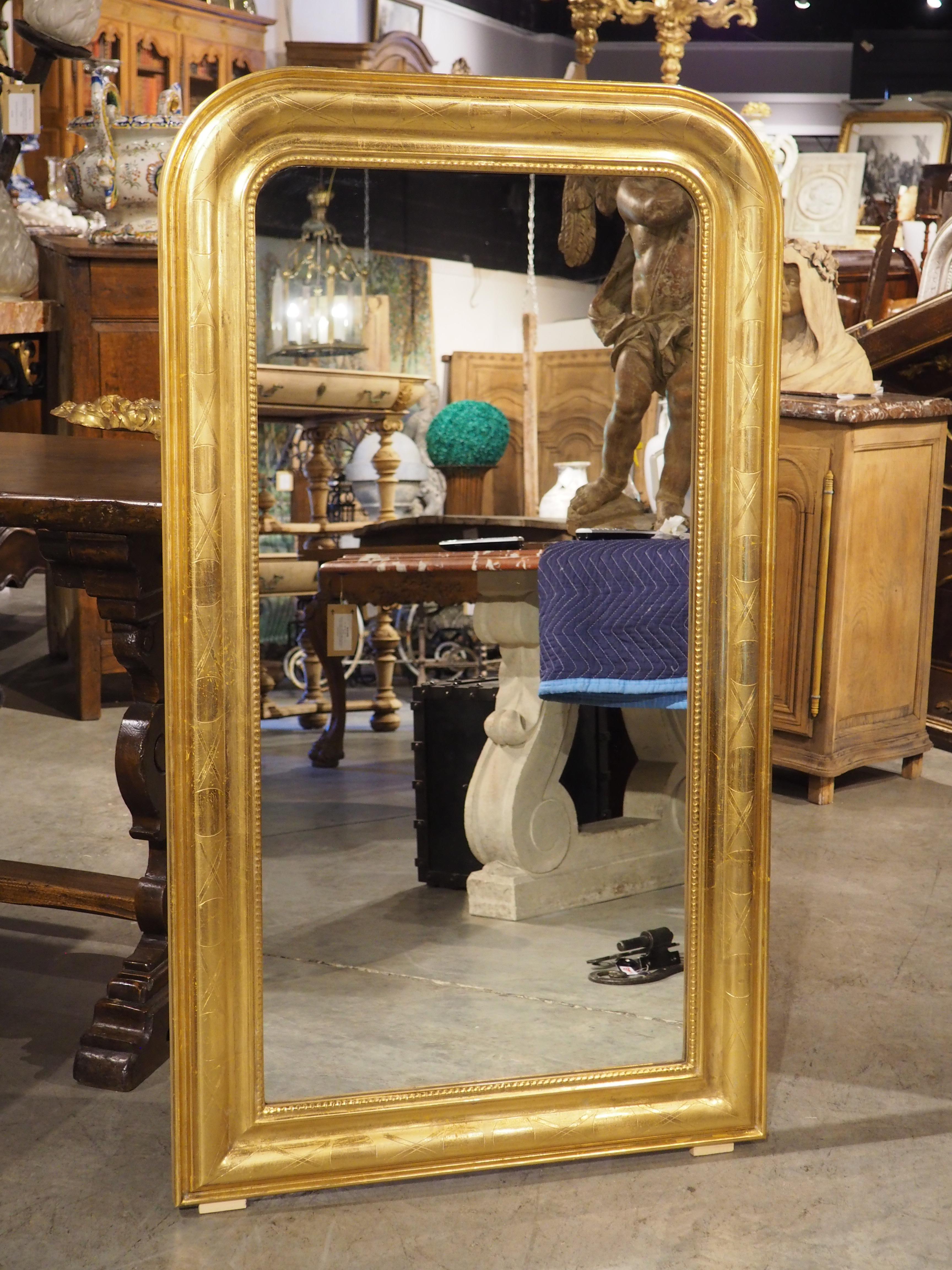 French Louis Philippe mirrors, such as this pair of gold leaf wall mirrors with geometric motifs from the 1900s, are always in high demand; they are highly versatile pieces that mesh well with just about any interior design style. The fact that
