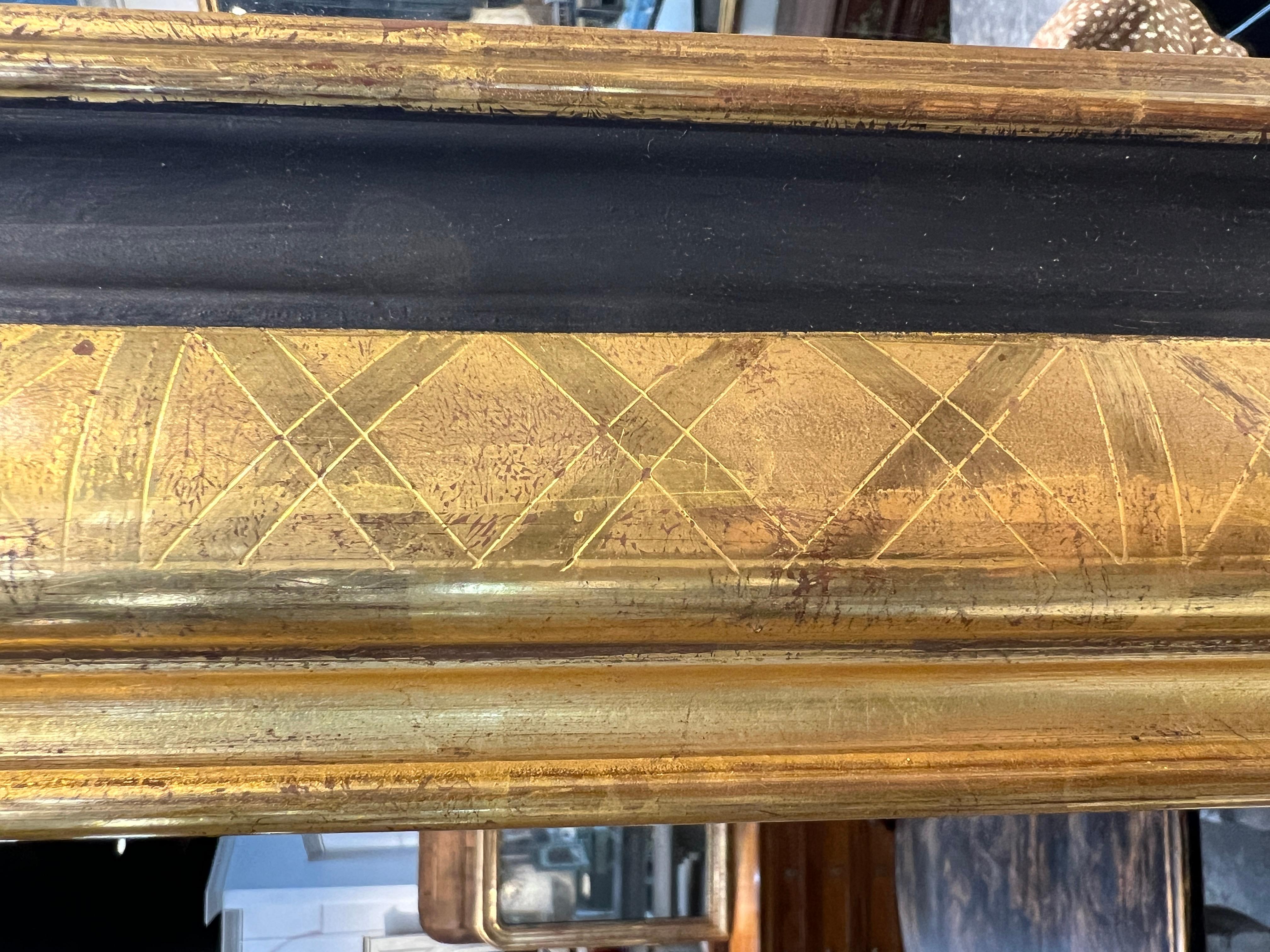 Handsome large pair of French Louis Philippe style mirrors, etched gold gilt on old wood frames accented with a painted black band.

Frame and backing of old wood, expertly applied gold gilt on etched frame.

Frames are intentionally made to appear