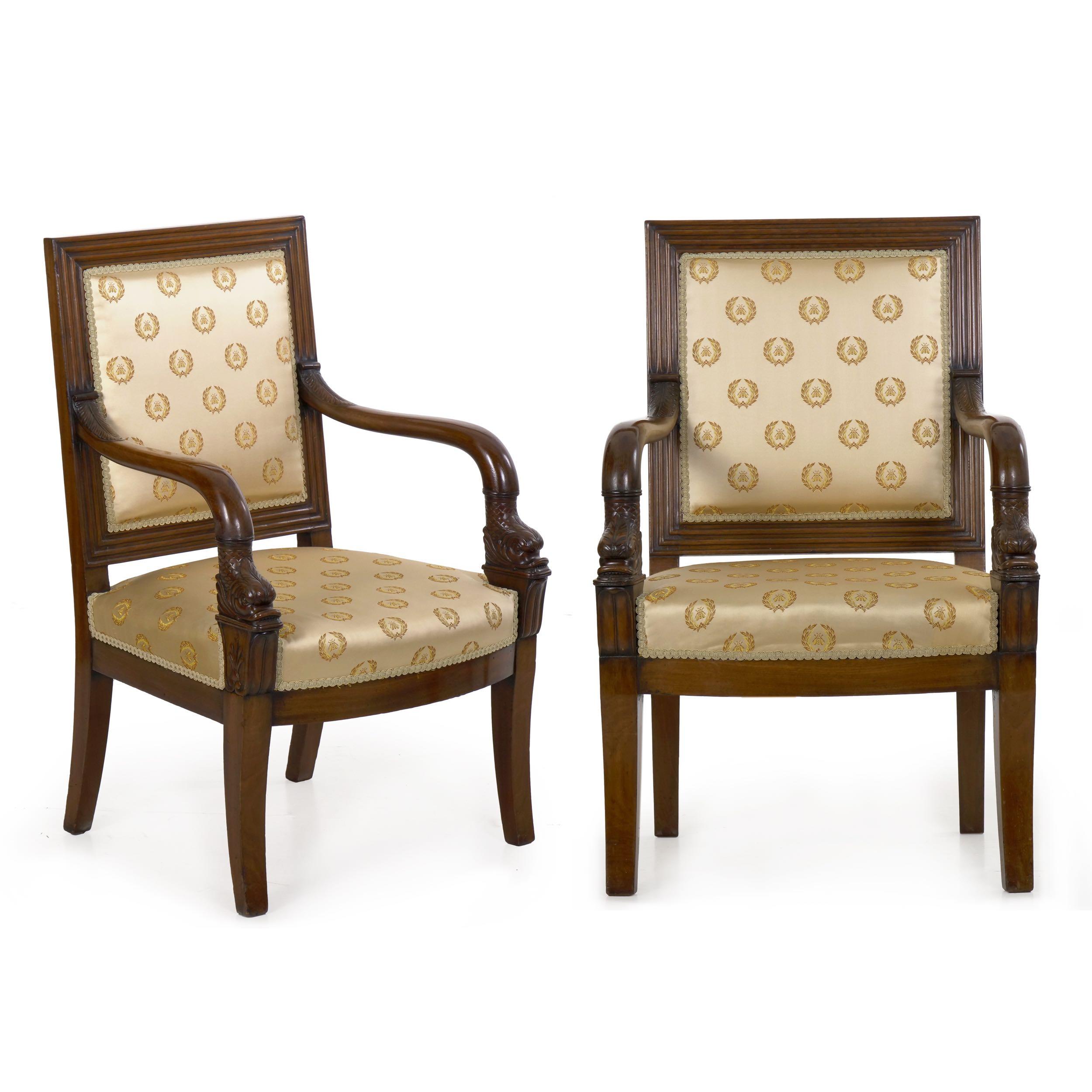 This very fine pair of armchairs is crafted from dense solid mahogany woods throughout, this nicely molded around the back with generous reeding that frames the stuffed and upholstered back. This is covered in an appropriate Napoleonic style fabric