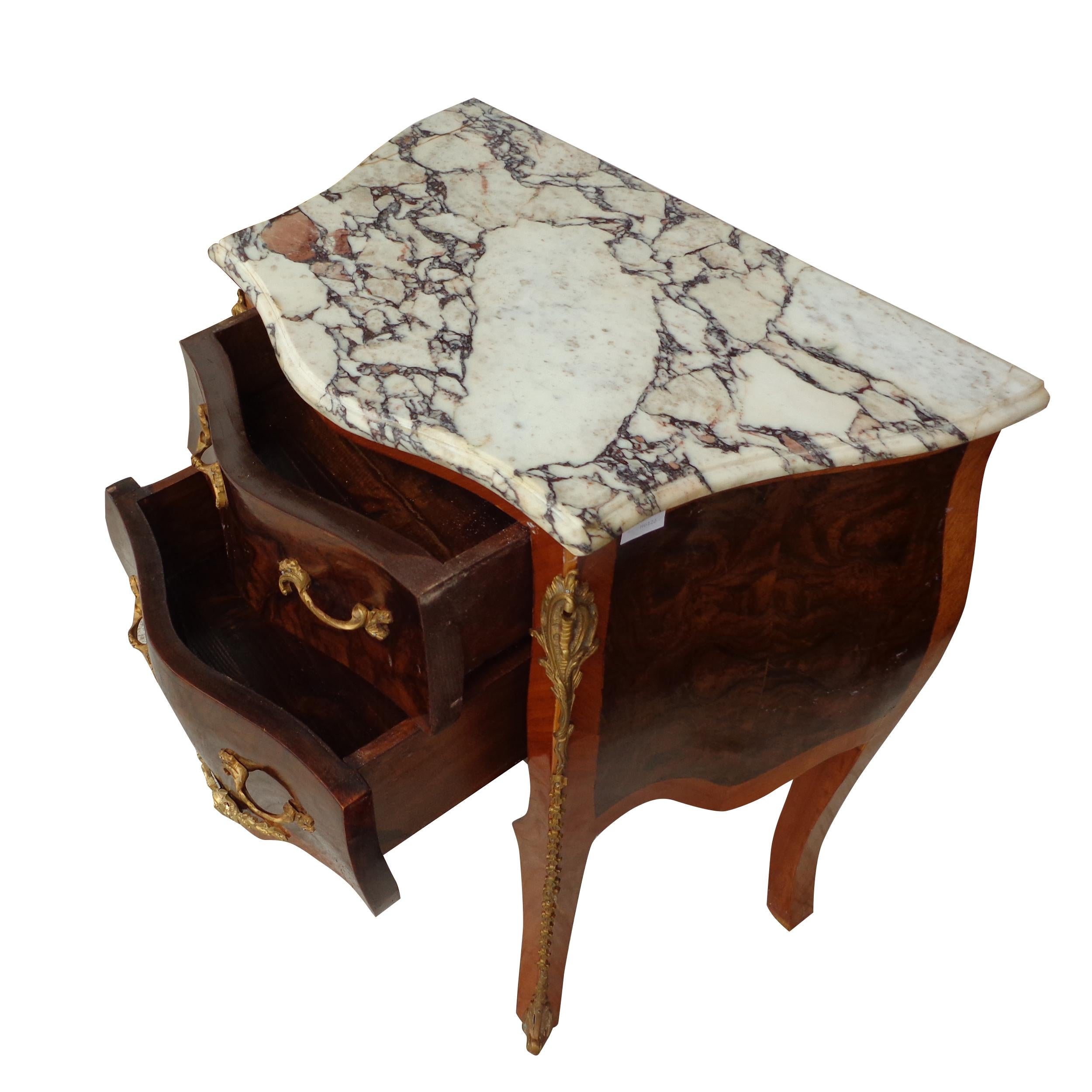 Pair of French Louis VI Style Commode Nightstands with Marble Tops

A pair of 2 drawer French commodes with parquetry inlays and beautiful bronze ormolu with  tops in calcutta marble. 
 