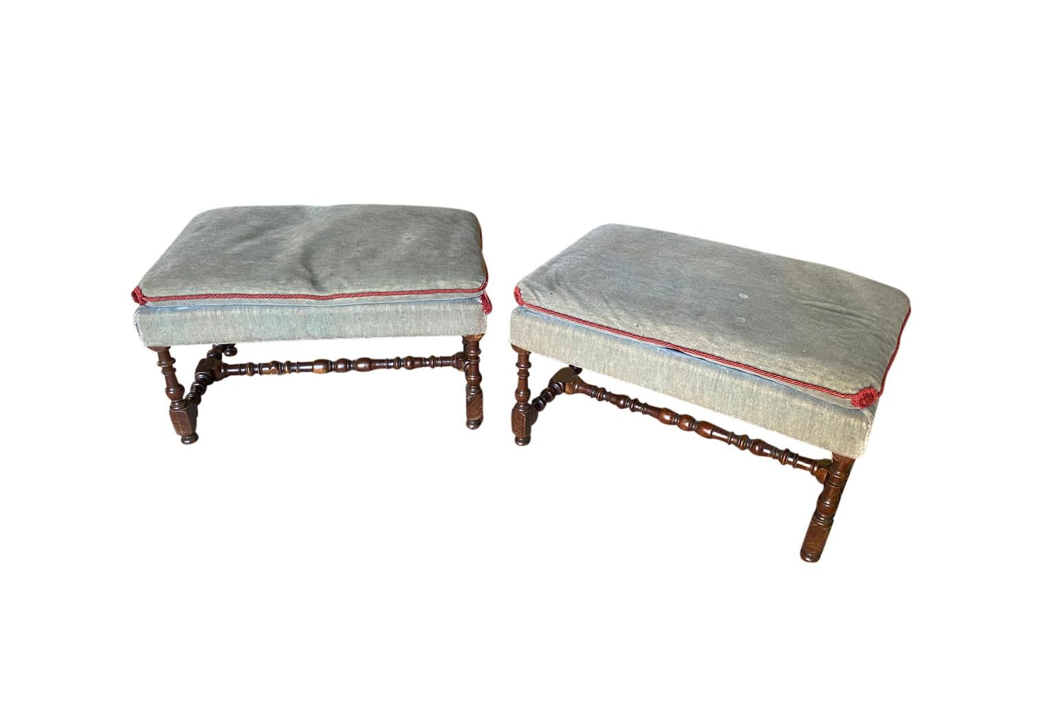 A very lovely pair of French Louis XIII style stools wonderfully constructed from richly stained chestnut with nicely turned legs and stretchers. Wonderful patina.