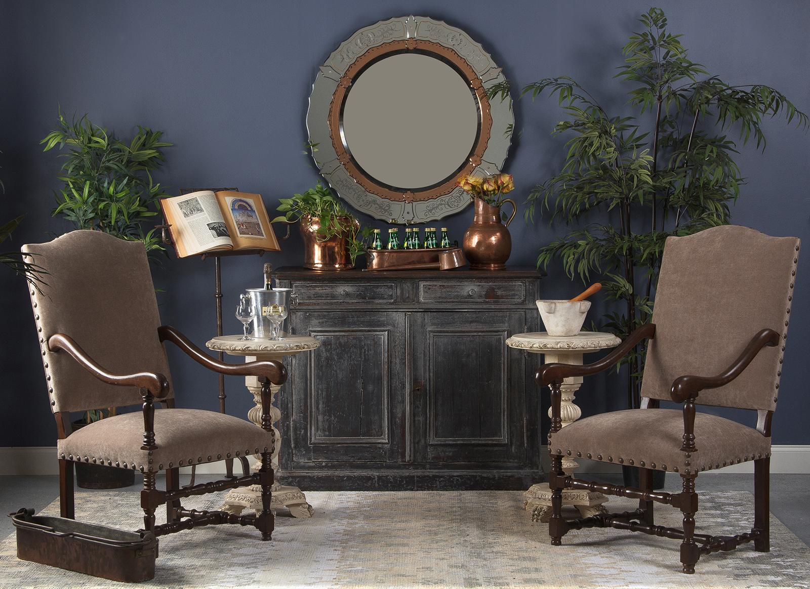 A large and comfortable pair of armchairs in the Louis XIII style. Curved arm rests, turned legs and an H-shaped stretcher are all comprised of warm toned beech wood. The seats and arched top backs are newly re-upholstered in taupe fabric with large