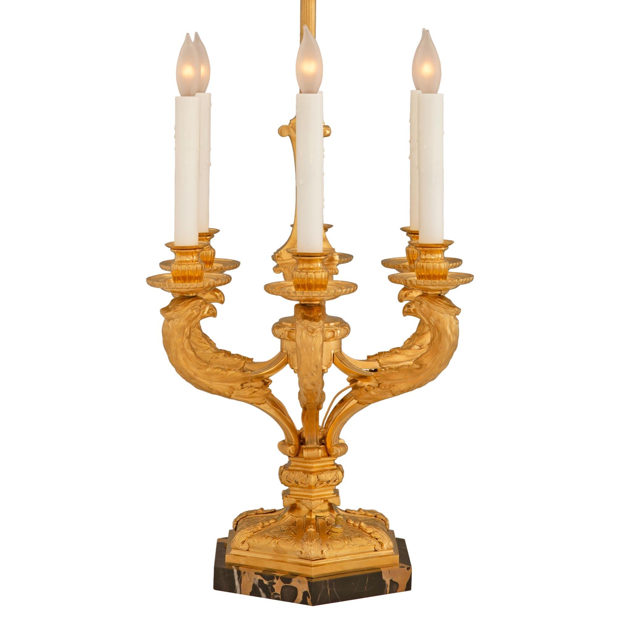 A most impressive and high quality pair of French 19th century Louis XIV st. ormolu and Portoro marble candelabra lamps signed Maison Bagues. The pair of six arm lamps are raised on hexagon shaped Portoro marble bases below an ormolu mount in a