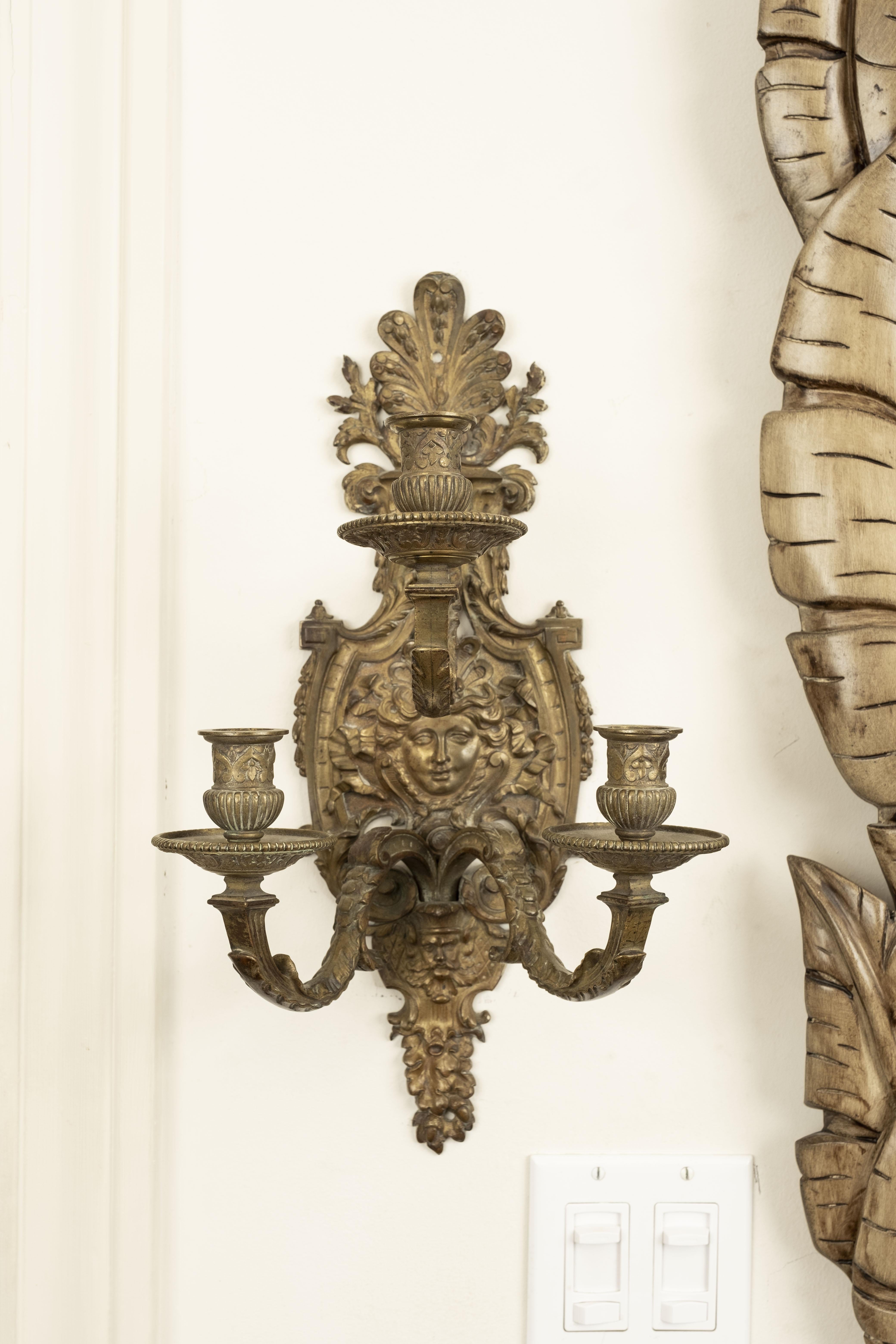 Pair of French Louis XIV style bronze sconces. These beautiful French bronze 3 light sconces are currently unwired. Could be used with candles or easily wired if desired. Great patina!