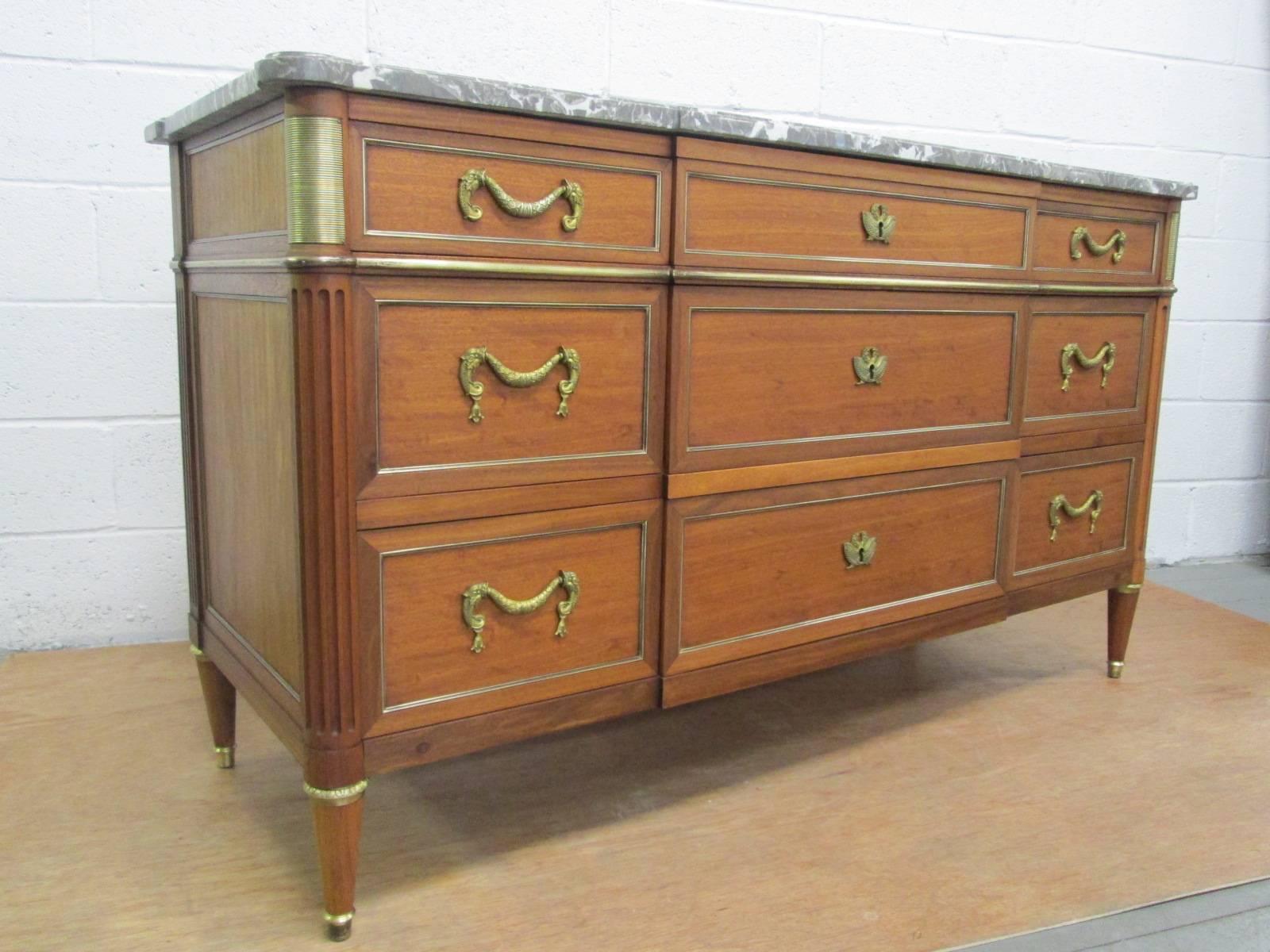 Pair of Louis XIV style French marble top dressers. Has bronze hardware and nine drawers.