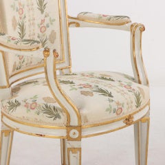 Pair of French Louis XIV style painted and gilt open arm chairs, C 1990.