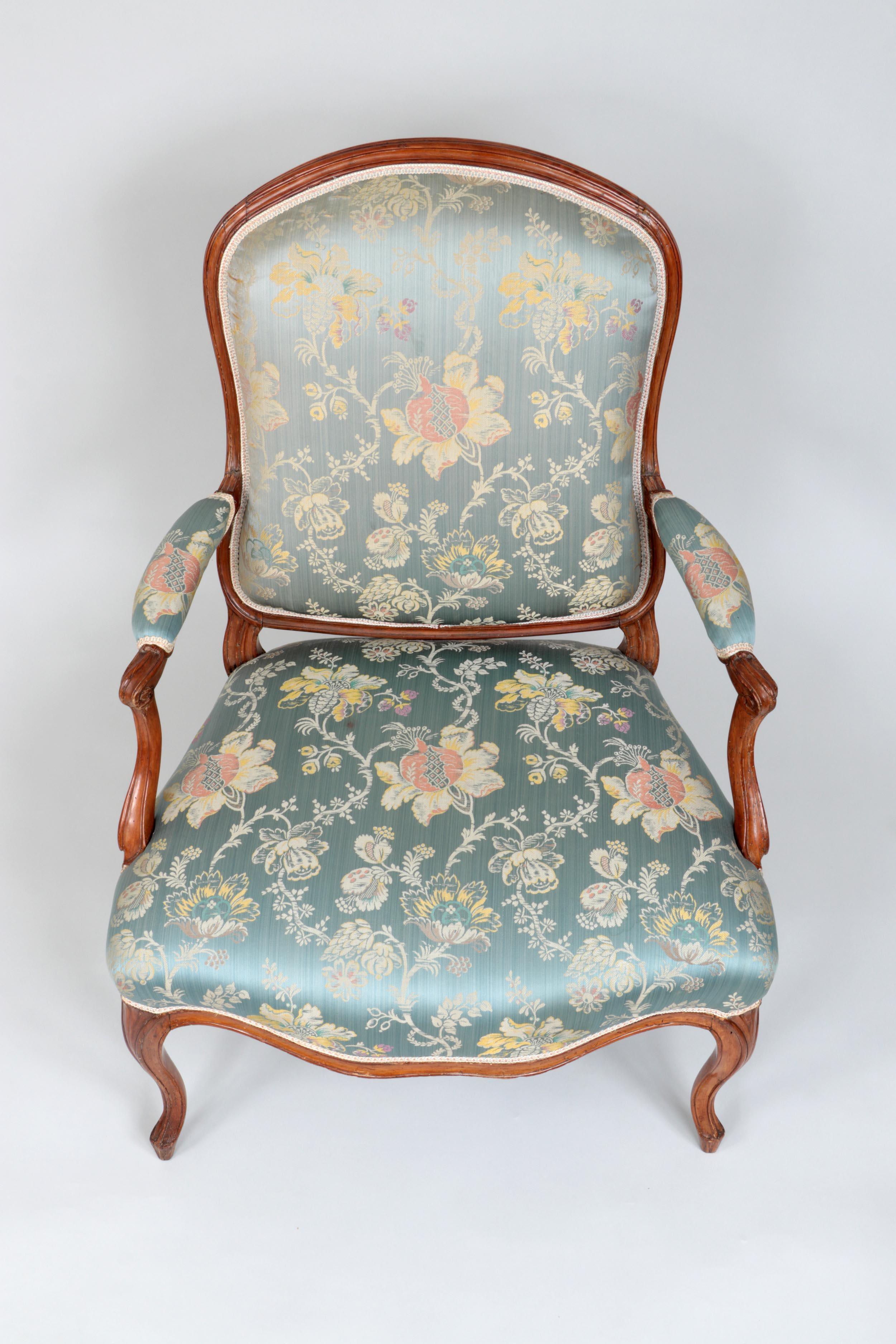 A fine pair of Louis XV period fauteuils in beech, circa 1760, France. The chairs are nicely sculpted with a simple arched back and elegant cabriolle legs and are a larger scale than most, making them great for contemporary sitters. Currently