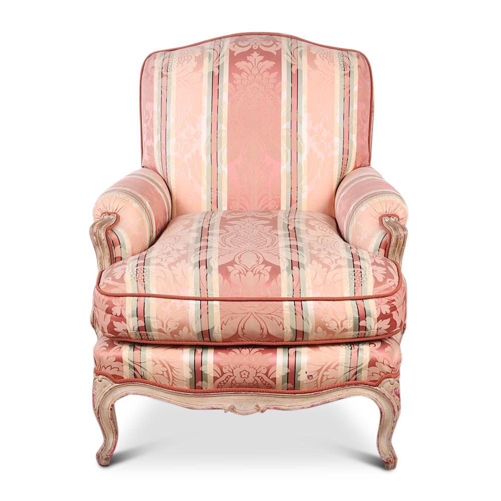 Pair of French Louis XV carved and painted armchairs. The exposed hand carved beechwood frames have elegant sinuous lines and a lovely distressed patina to the painted finish. These are very sturdy and comfortable chairs suitable for everyday