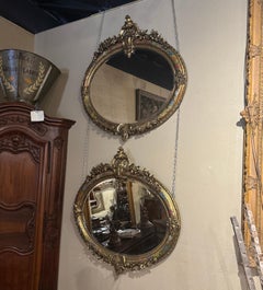 Pair of French Louis XV Carved Giltwood and Paint-Decorated Beveled Oval Mirrors