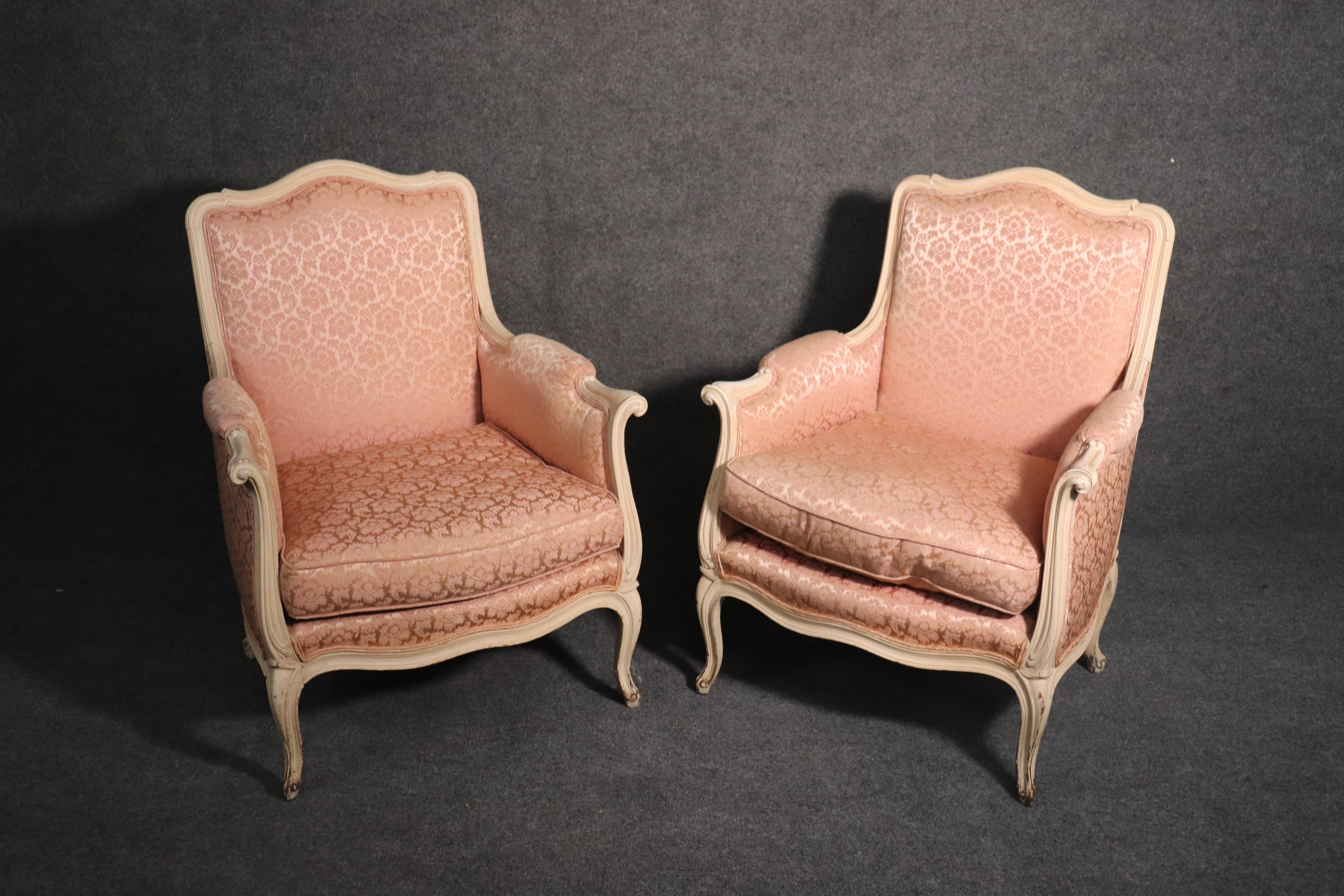 This is a beautiful pair of French Louis XV style crème painted chairs in beautiful pink damask upholstery. The fabric is in good condition with no major issues or problems to mention. The frames are in good condition as well. They measure 36 tall x