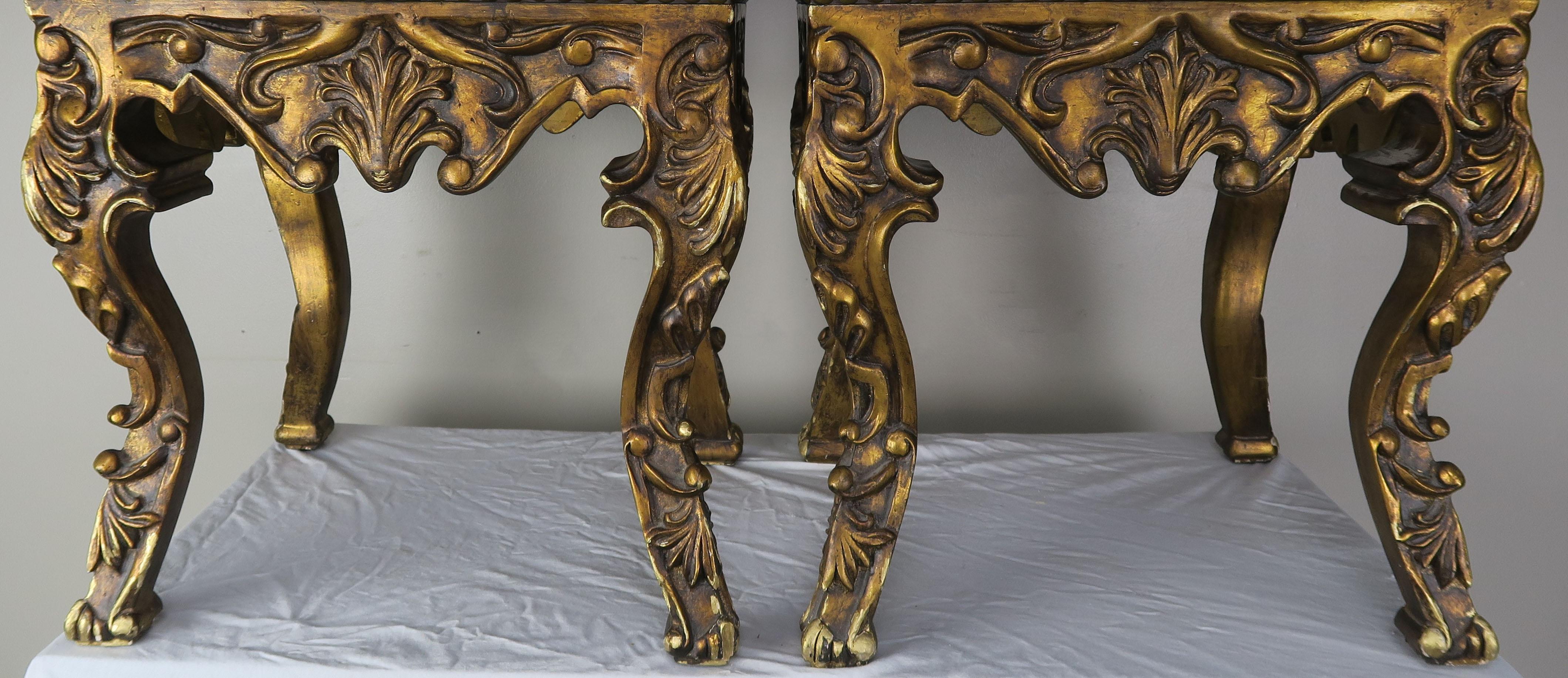 Pair of French Louis XV leather benches upholstered in brown colored leather with antique brass colored nailhead twin detail. Beautiful carving throughout the antique giltwood finish. The benches stand on four cabriole legs that are beautifully