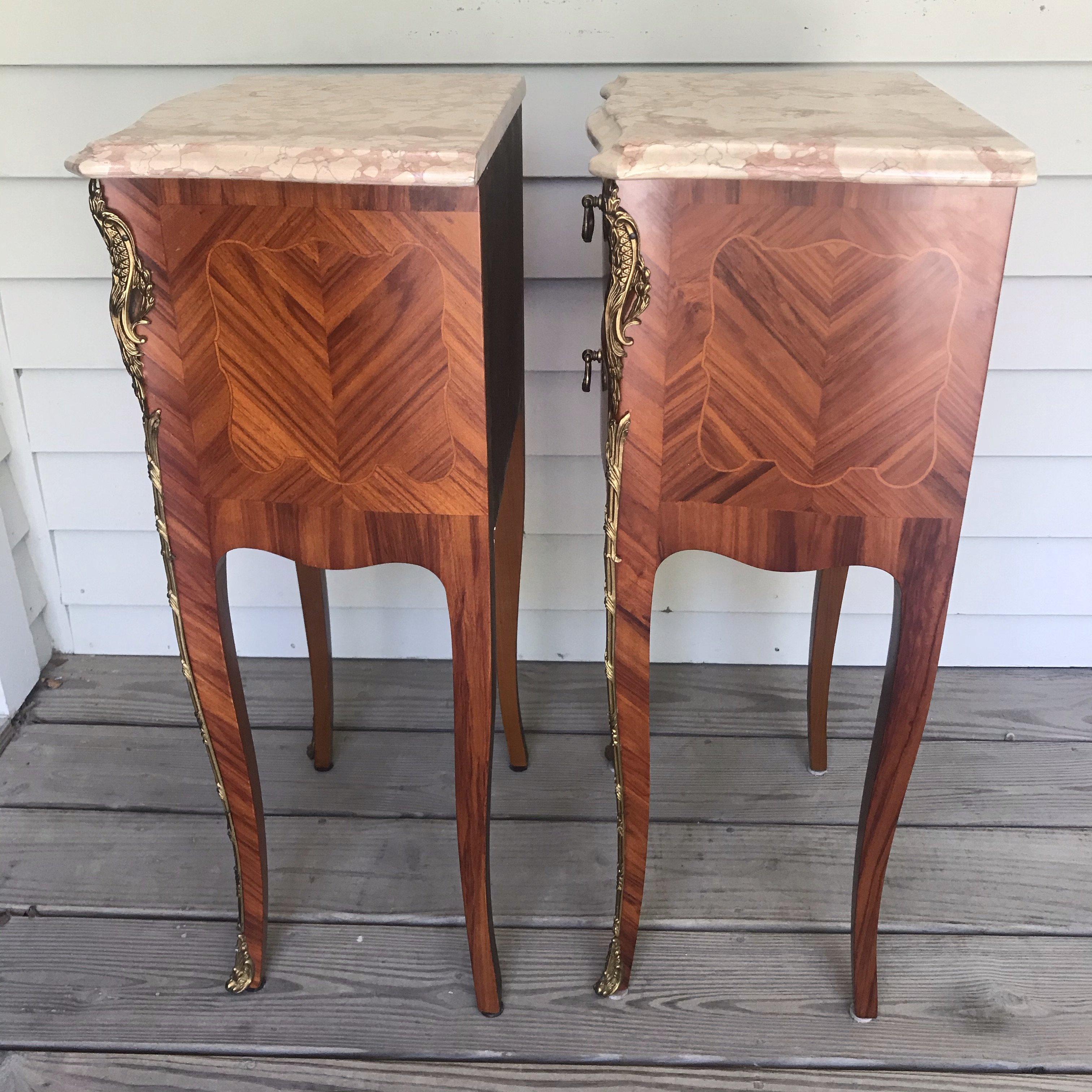 Pair of lovely French Louis XV marble-top nightstands from Lyon, France having gorgeous brass decoration and hard ward, elegant cabriole legs and 2 drawers in each.

#4525.