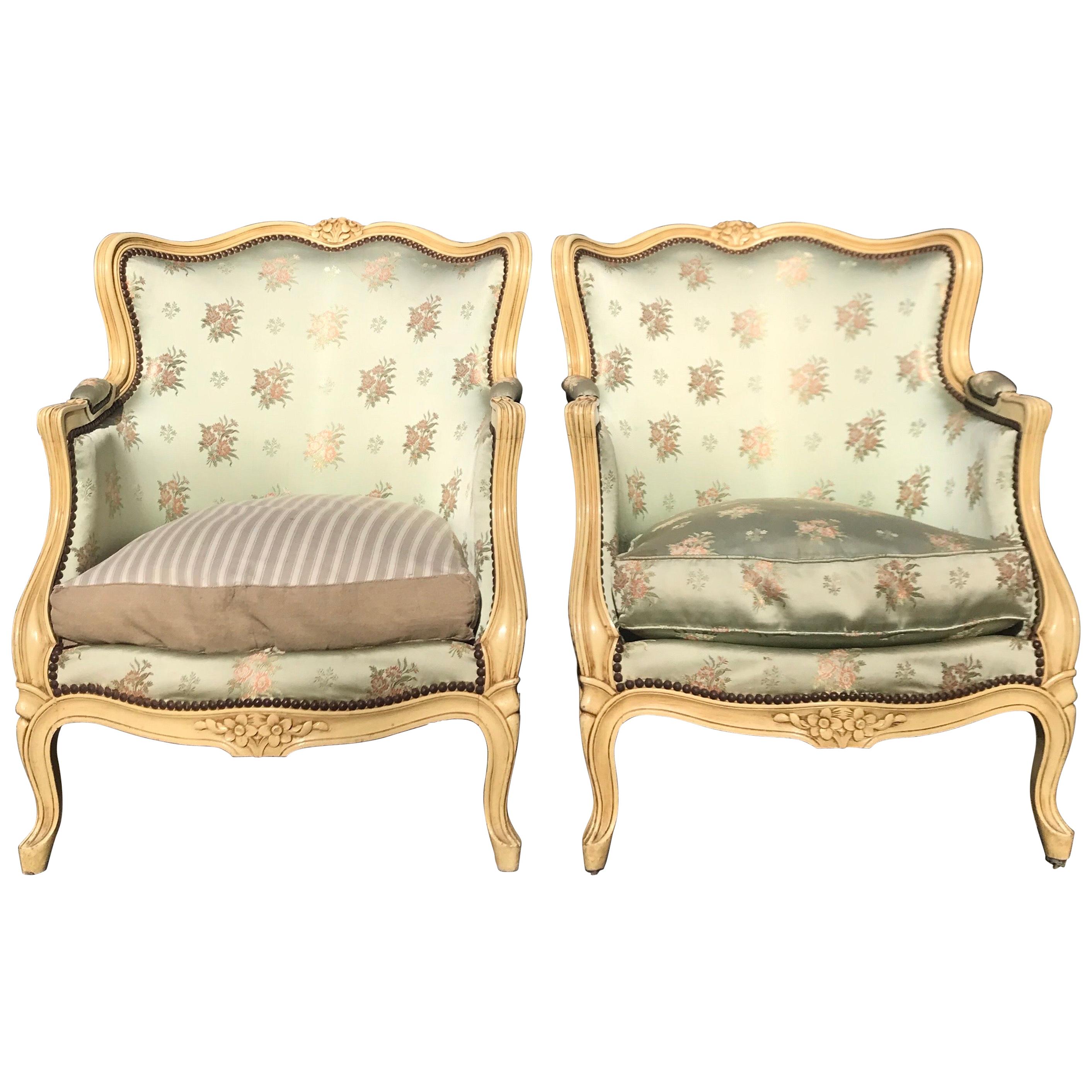 Pair of French Louis XV Painted Bergere Chairs with Beautifully Carved Flowers For Sale