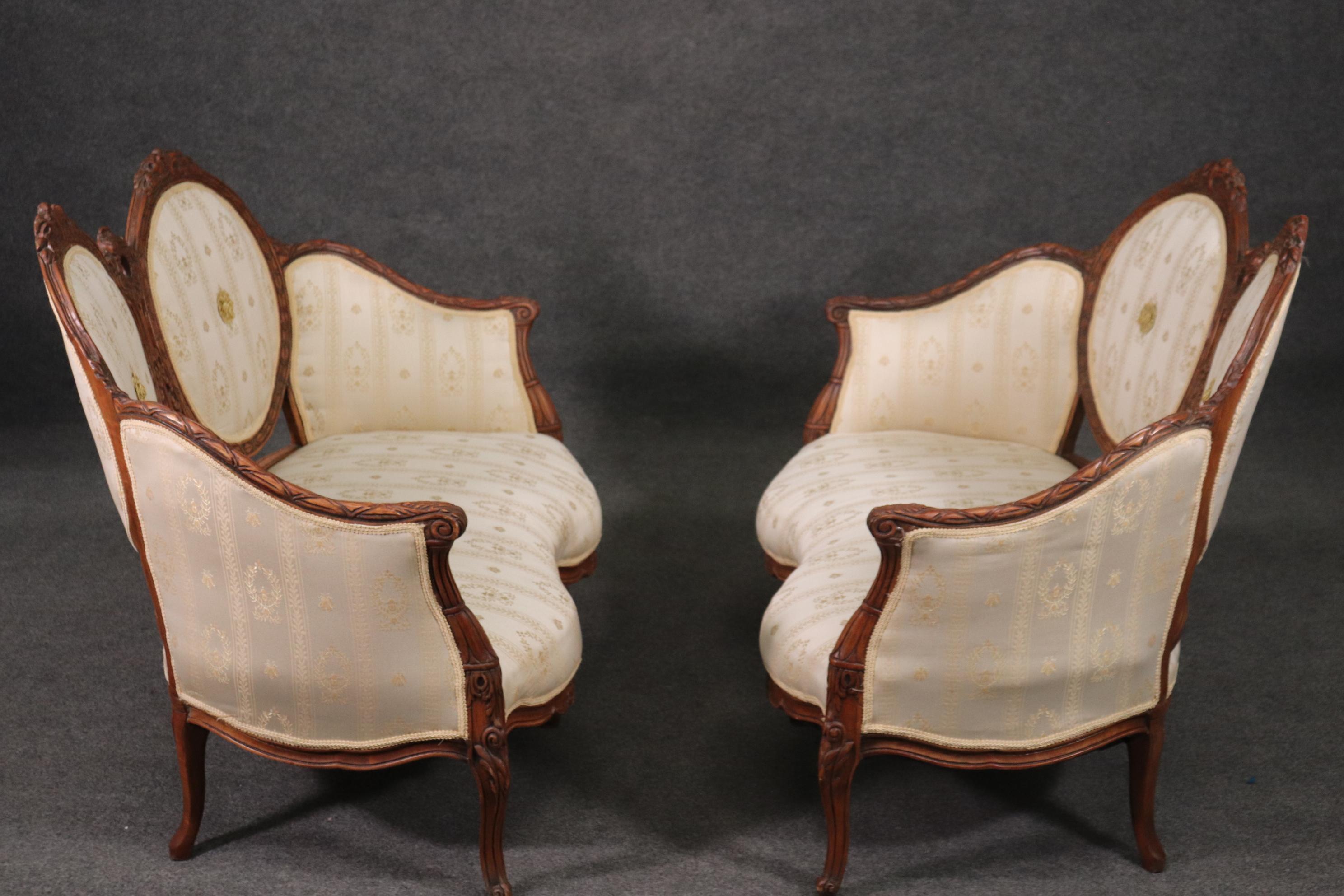 This is a superb pair of French style walnut settees. They are in beautiful upholstery and have great lines. They each measure 49 wide x 31 deep x 37.5 tall x 14.5 inch seat height. They date to the 1920s.