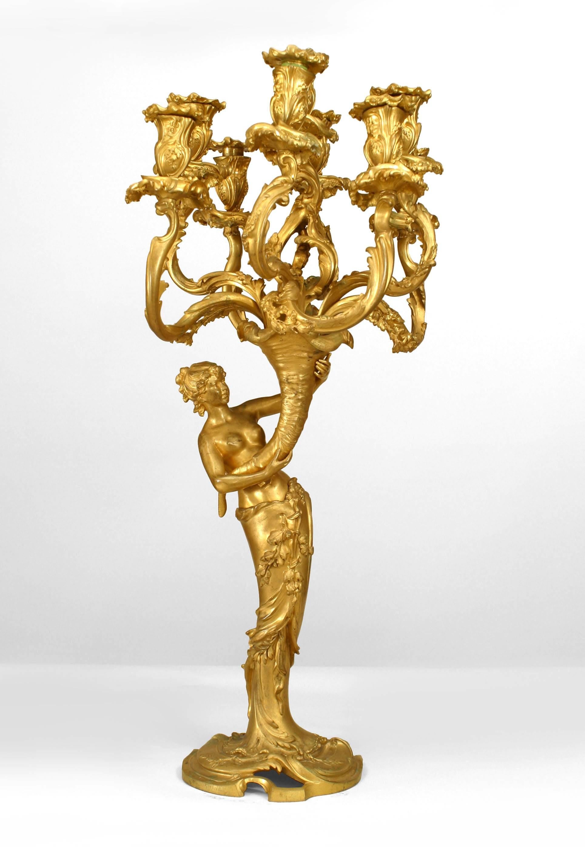 Pair of French Louis XV style (19th century) gilt bronze Bacchus and Bacchante figures holding nine-arm candelabra.
