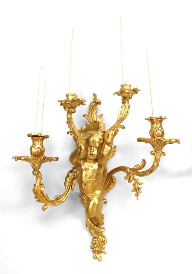 Pair of French Louis XV-style (19th Century) bronze dore wall sconces with four arms wall sconces and cupid figures. (PRICED AS Pair)
