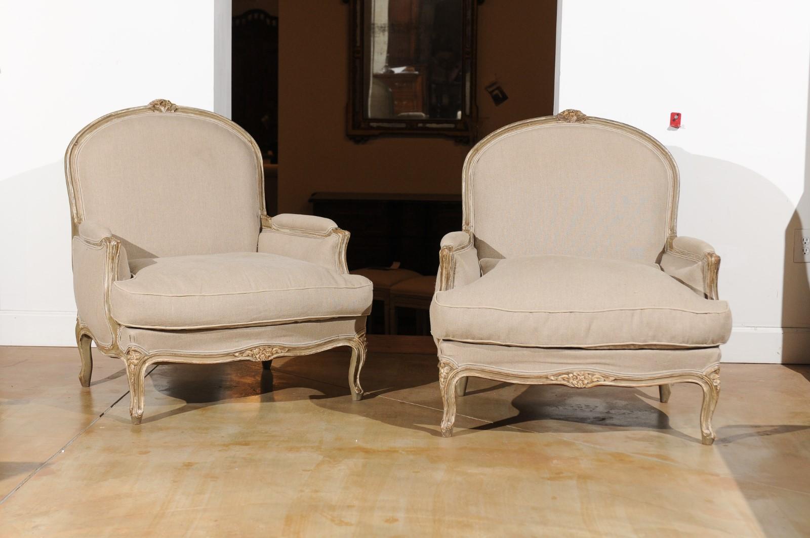 A pair of French Louis XV style painted wood marquises chairs from the 19th century, with carved crest, cabriole legs and new upholstery. Born in France during the 19th century, each of this pair of marquises presents the stylistic characteristics