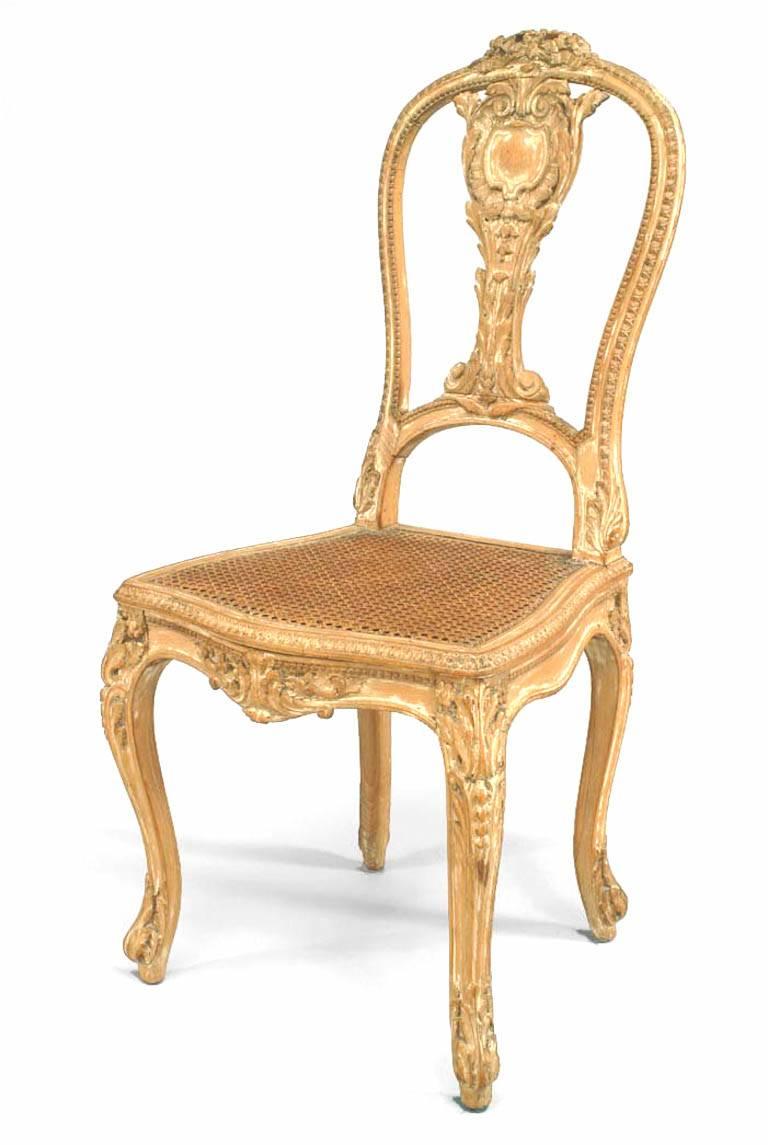 Pair of French Louis XV style (19th century) stripped side chairs with carved splat back and cane seat.
 