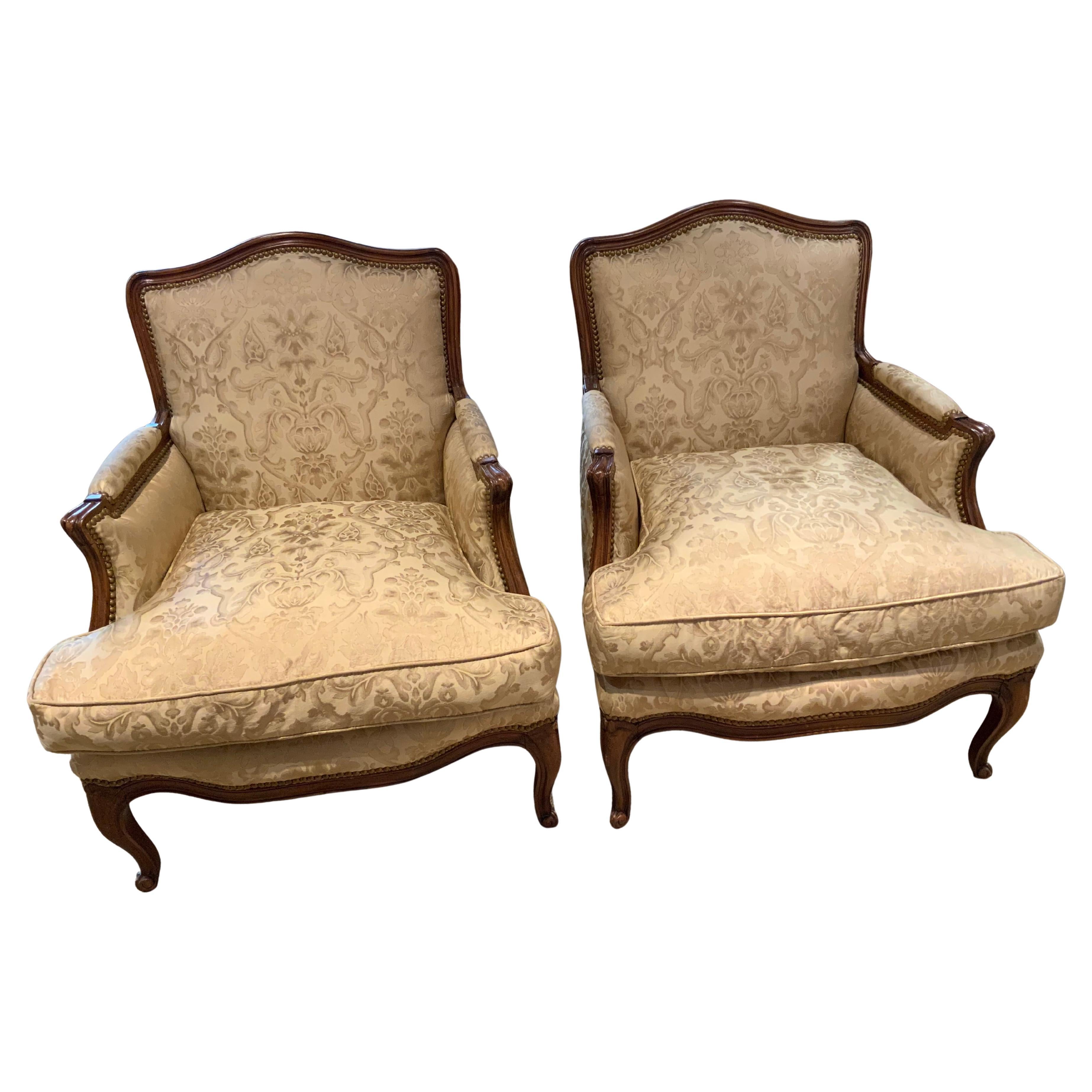Pair of French louis XV style bergere arm chairs upholstered in silk Fortuny