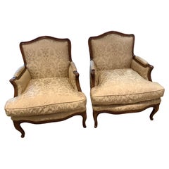Pair of French louis XV style bergere arm chairs upholstered in silk Fortuny