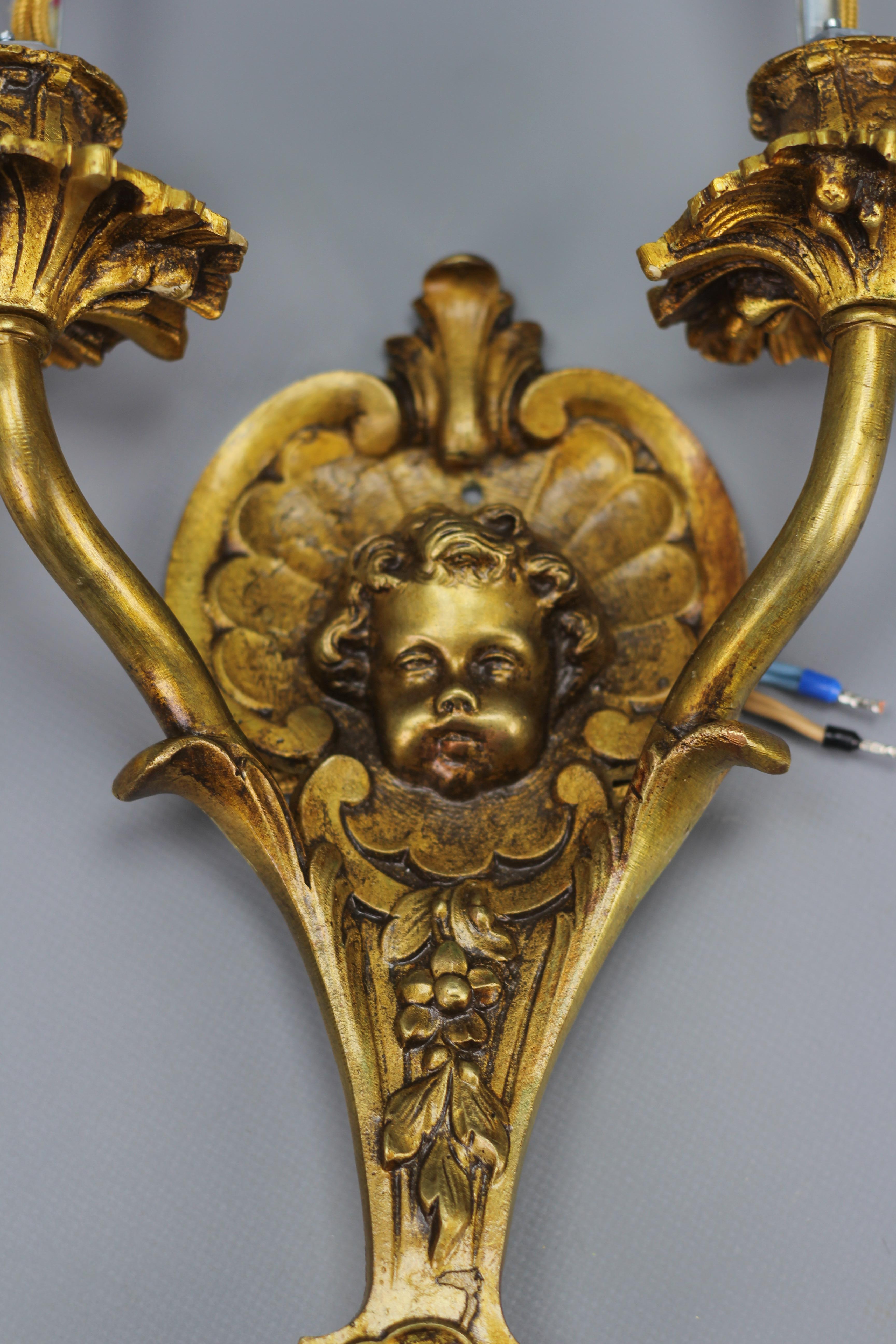 Zwei französische zweiarmige Bronze-Wandleuchter im Louis-XV-Stil mit Puttenkopf, 1930er Jahre im Angebot 2