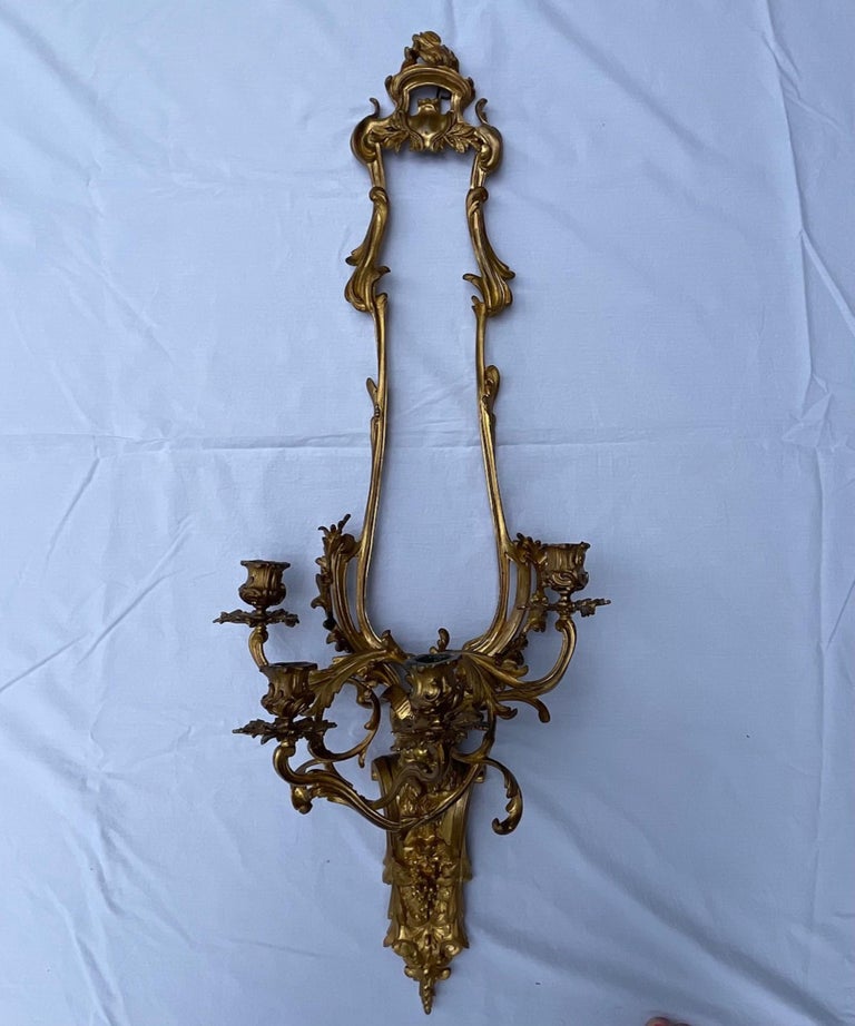 Pair of French Louis XV style bronze four light sconces

Important antique pair of fire gilded bronze wall sconces. They are unusual and of exceptional quality. This rare model with finely casted and chiseled bronze focuses on foliage and acanthus