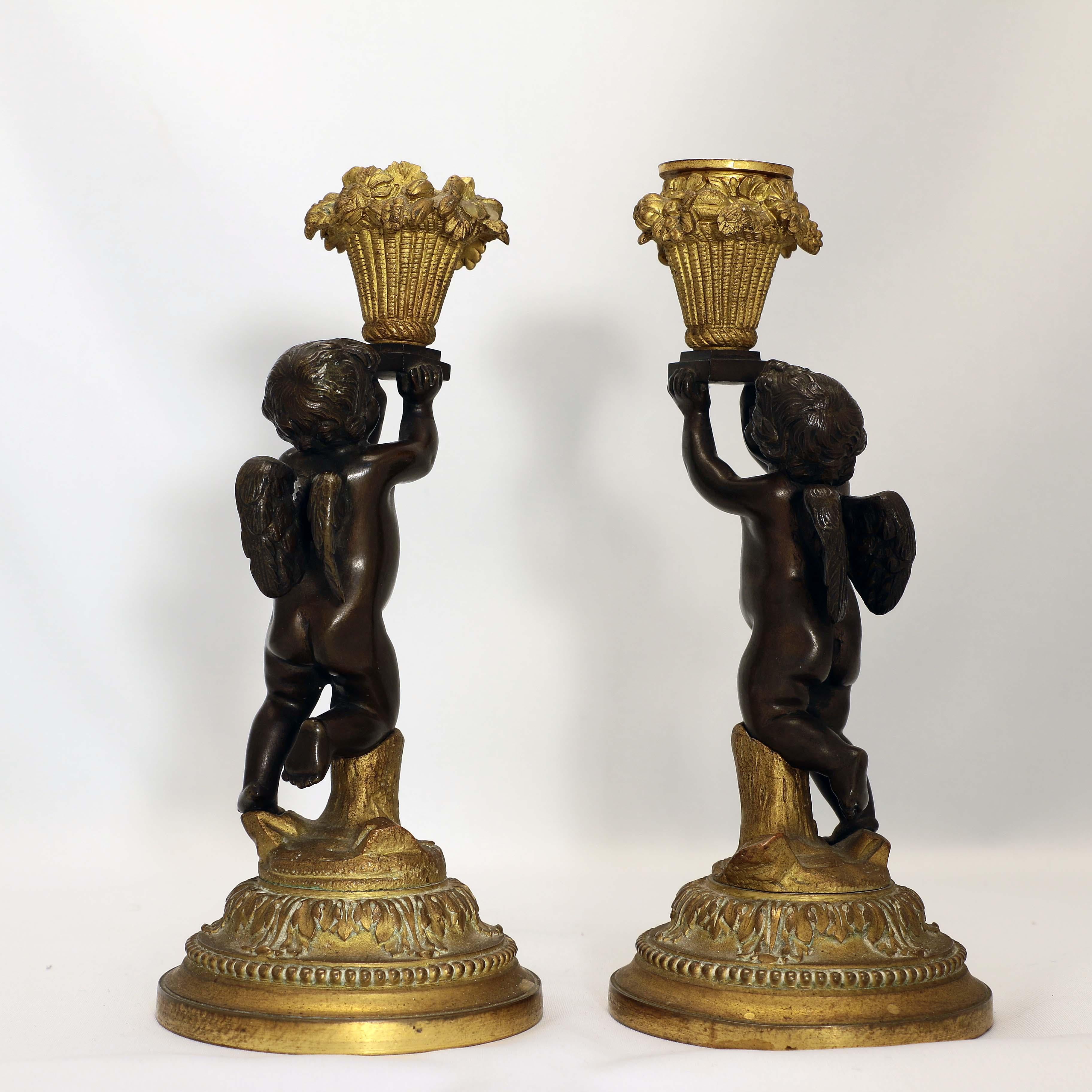 Cast Pair of French Louis XV Style Candlesticks, Modelled as Cherubs with Baskets