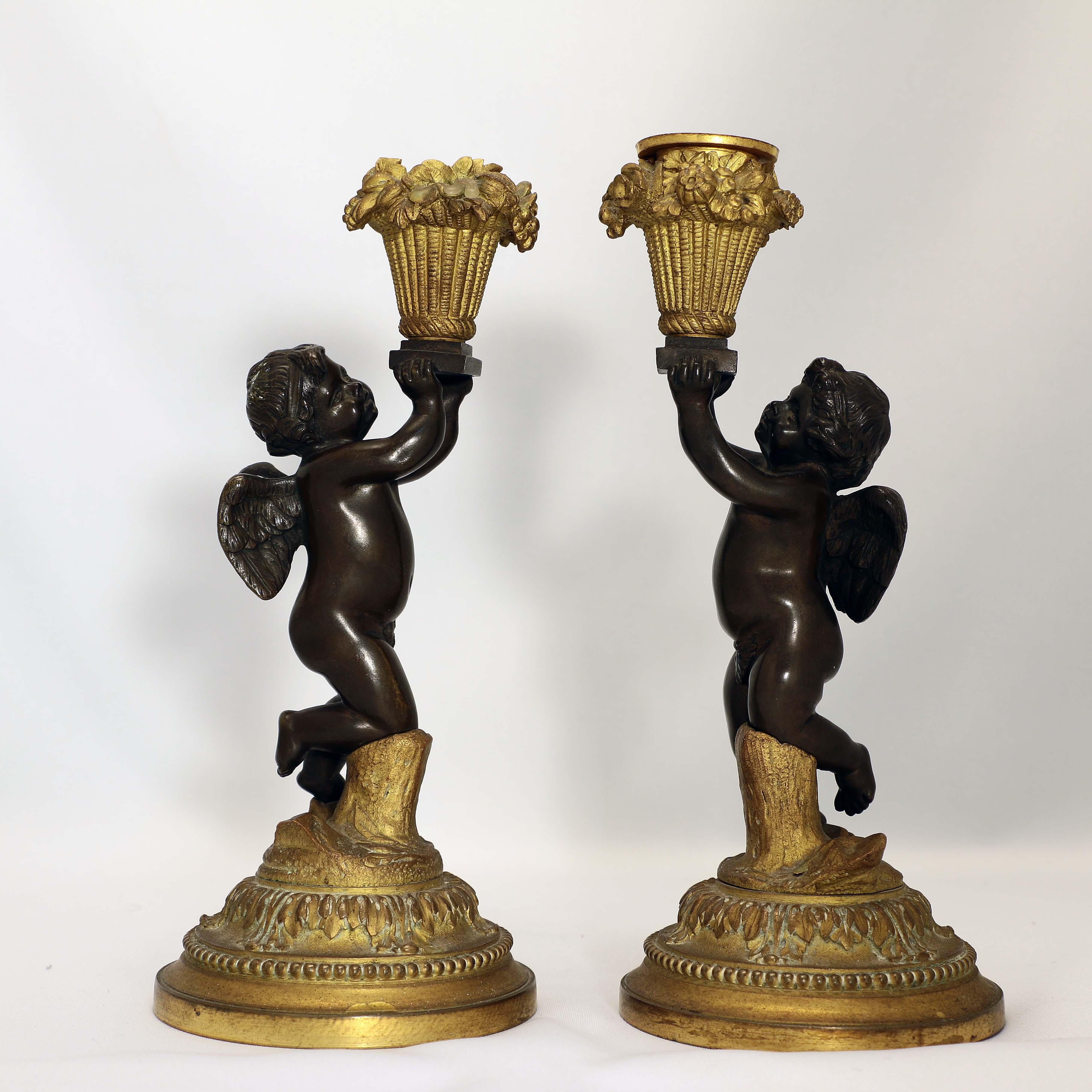 Late 19th Century Pair of French Louis XV Style Candlesticks, Modelled as Cherubs with Baskets