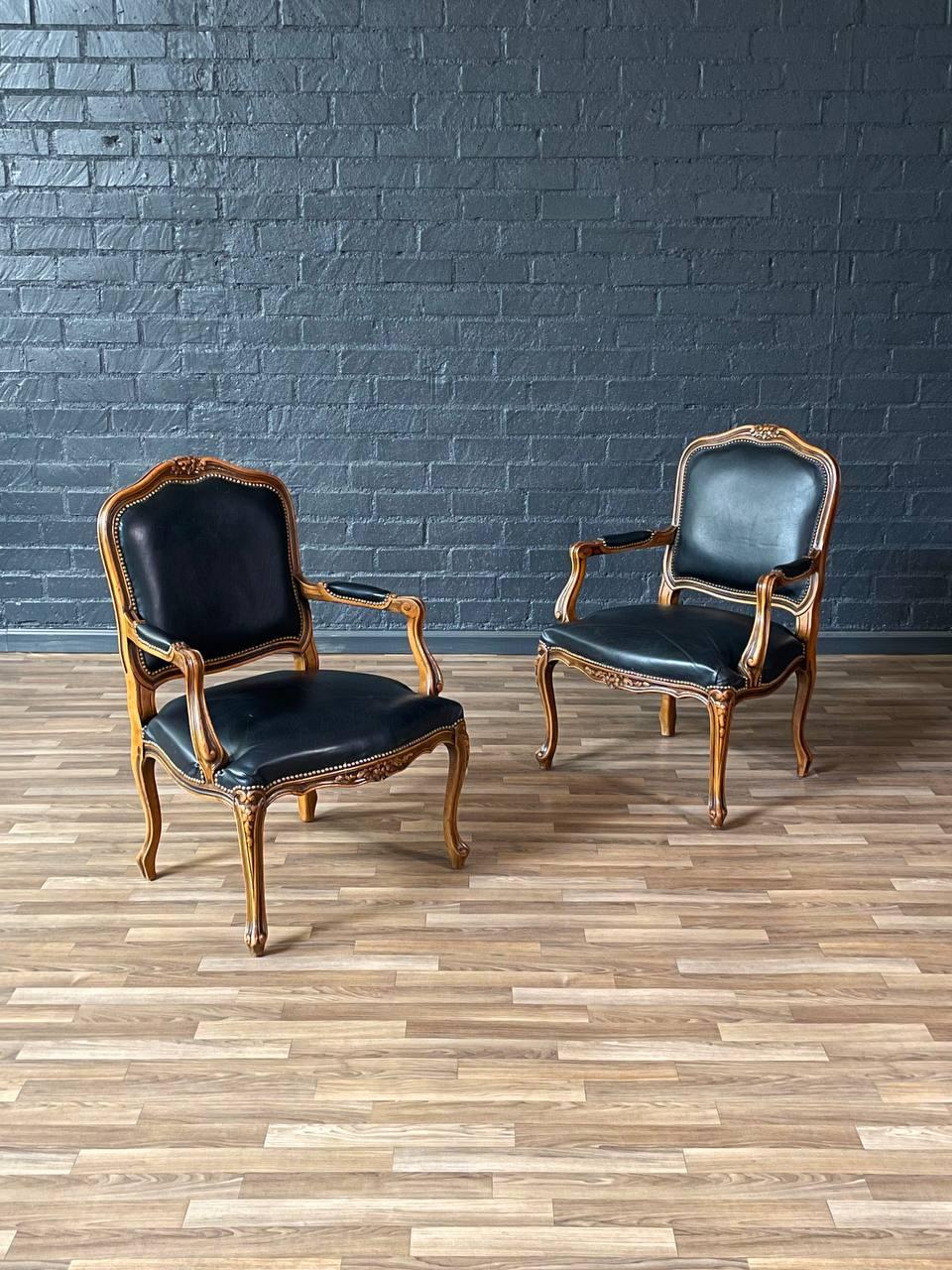 Condizioni: Condizioni originali d'epoca 
Materiali: Legno di faggio, pelle nera originale 
Stile: Francese Luigi XV

Questa elegante coppia di poltrone francesi in stile Luigi XV è stata progettata e prodotta da Chateau d'Ax in Italia durante gli