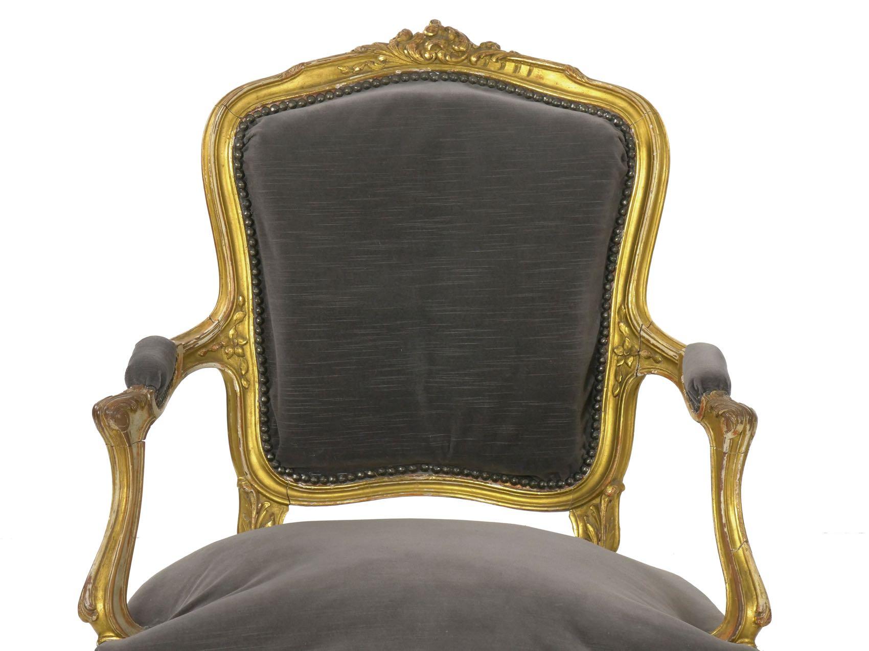 This striking pair of Louis XV style fauteuils retain an original and rather early gilding naturally worn down to the gesso in some areas over a vibrant carved surface. The chairs exhibit a skilled carver’s hand, the displays mostly of acanthus and