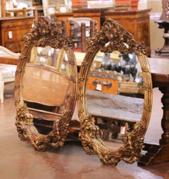 Pair of French Louis XV Style Carved Patinated Giltwood Oval Wall Mirrors