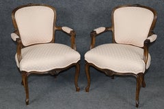 Pair of French Louis XV Style Carved Walnut Armchairs