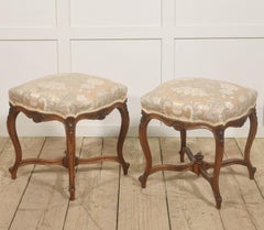 Pair of French Louis XV–Style Carved Walnut Stools