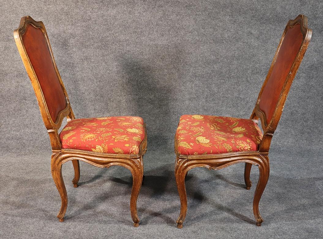 These French Louis XV style carved walnut chairs are mortice and tenon joined and date to the early to middle part of the 1800s. They are beautifully carved and true to the period and have leather backs and cloth seats. These chairs are perfect for