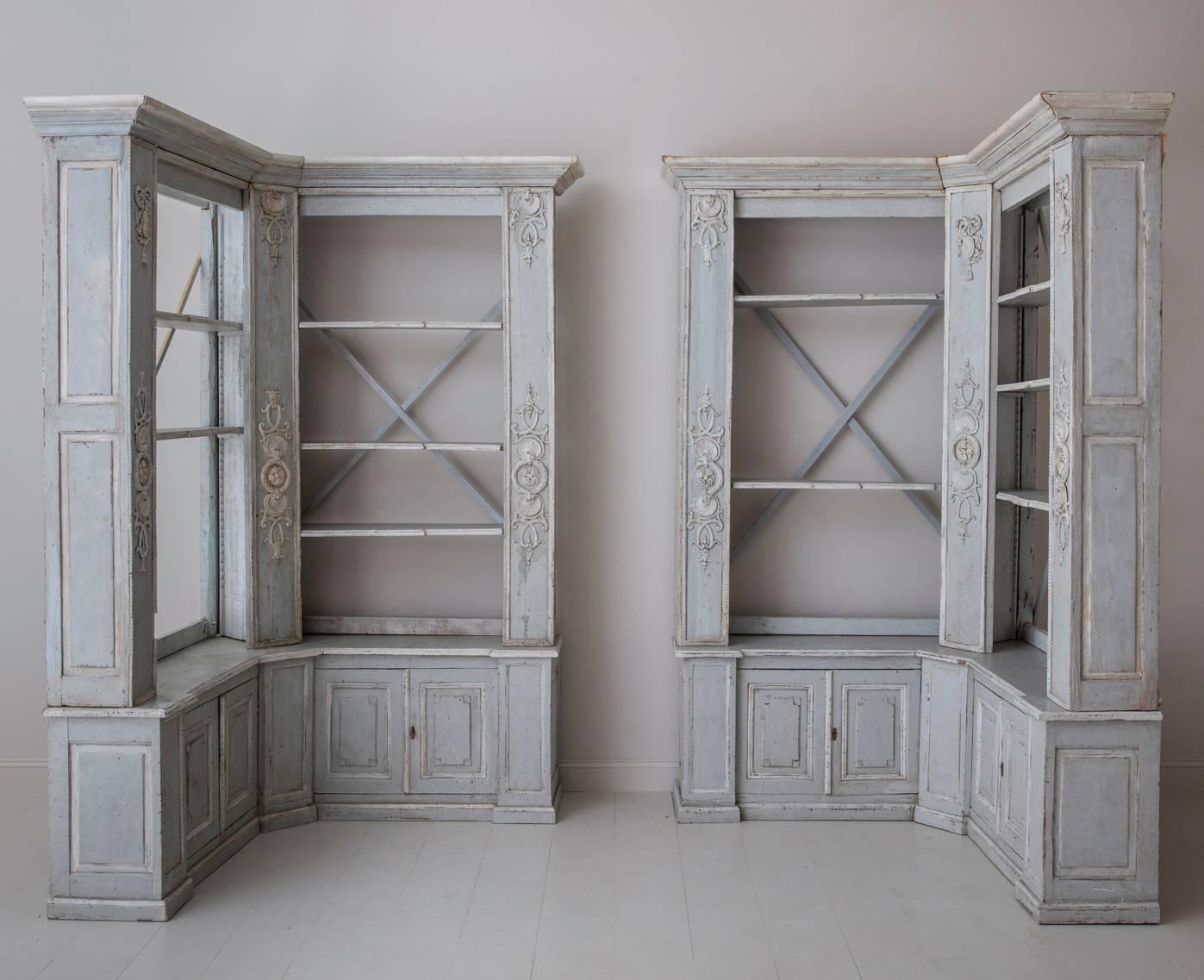 A rare pair of corner bookcases in the Louis XVI style. This piece marries the original 19th century construction of the lower corner cabinets and upper frame with the newer construction of the interior cabinetry and open shelving. Beautifully