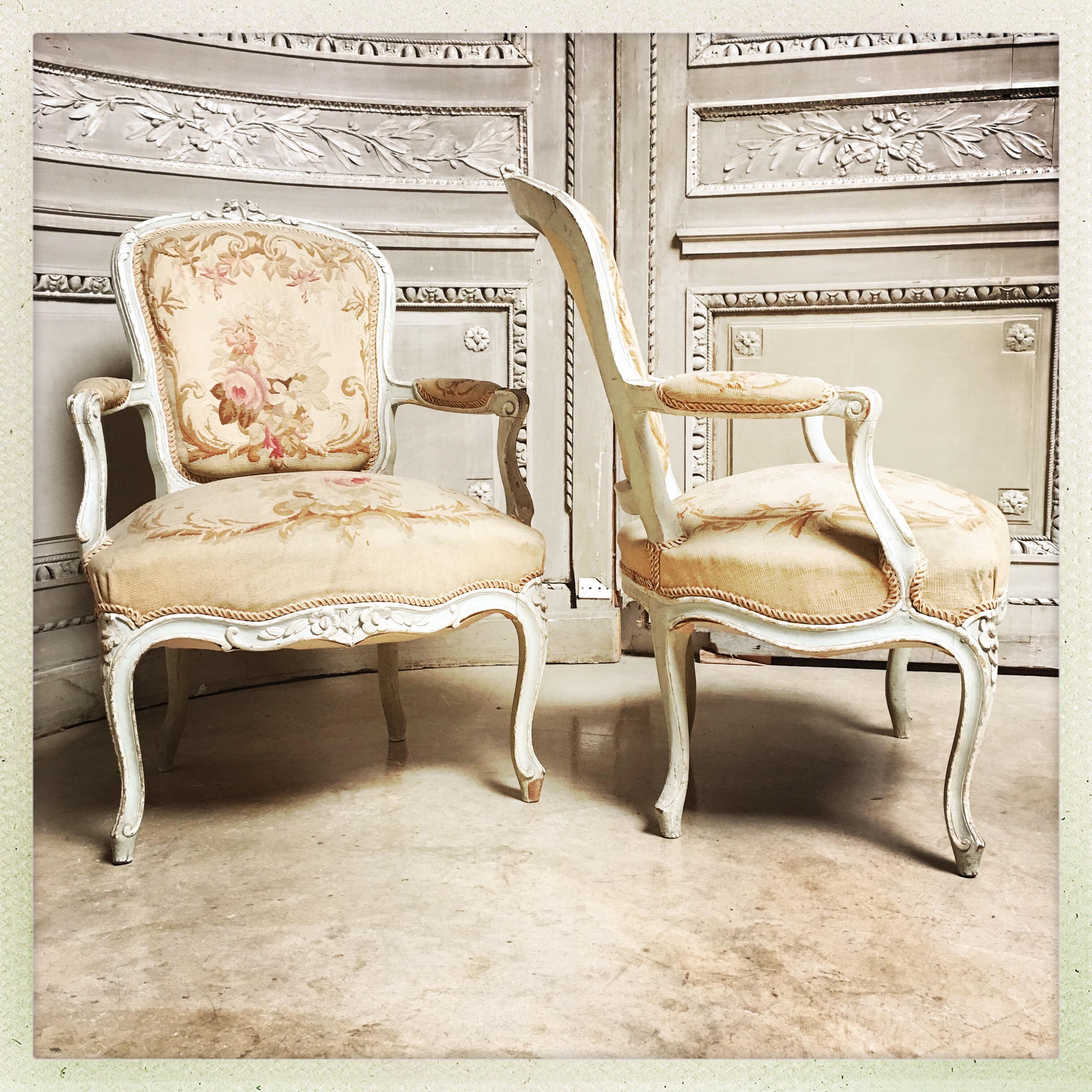 A pair of French Louis XV style fauteuils with a beautiful old painted finish and Aubusson tapestry upholstery.