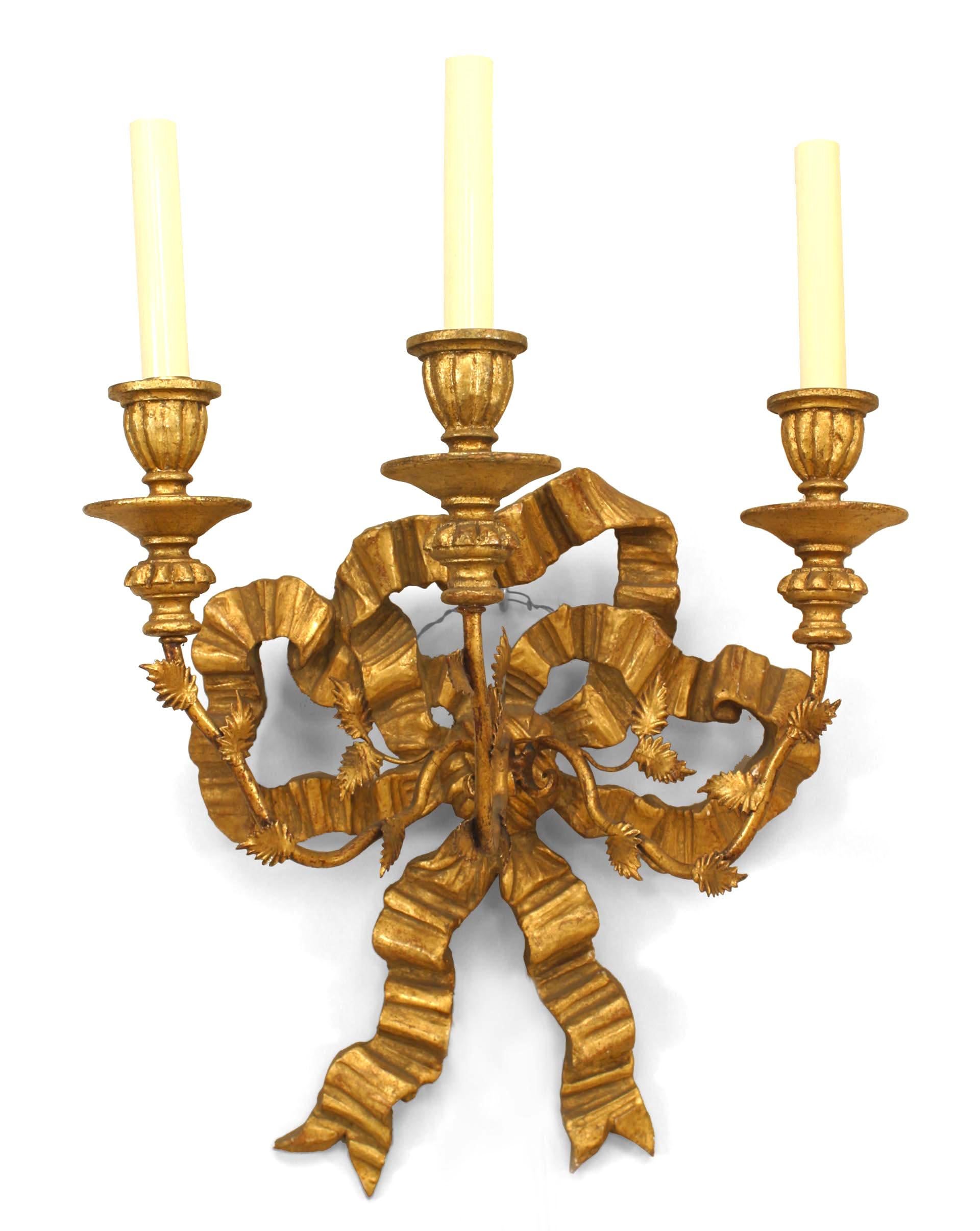 Pair of French Louis XV style gilt (19th-20th century) wood bow knot back wall sconces with 3 gilt metal arms.
