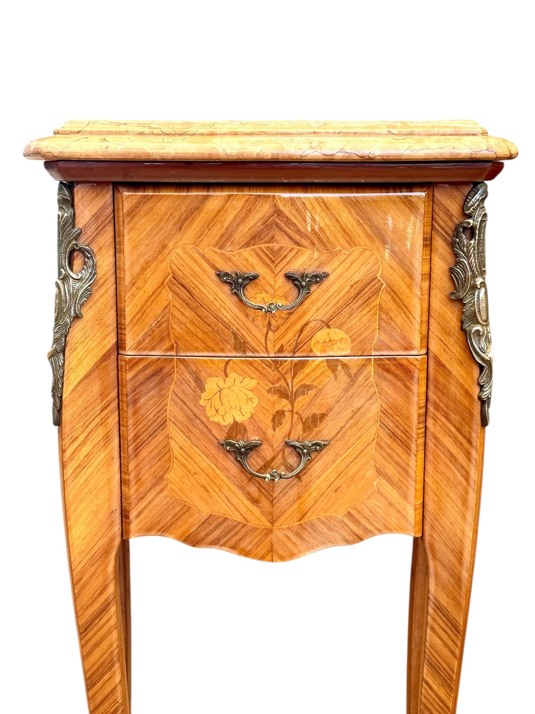 Cette élégante paire de tables de nuit françaises de style Louis XV témoigne du raffinement de l'artisanat et du charme intemporel des meubles de la fin du XIXe siècle et du début du XXe siècle. Chaque pièce est finement plaquée d'une marqueterie