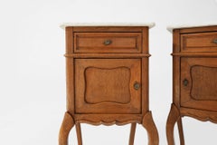 Pair of French Louis XV style nightstands in oak with Carrara marble top