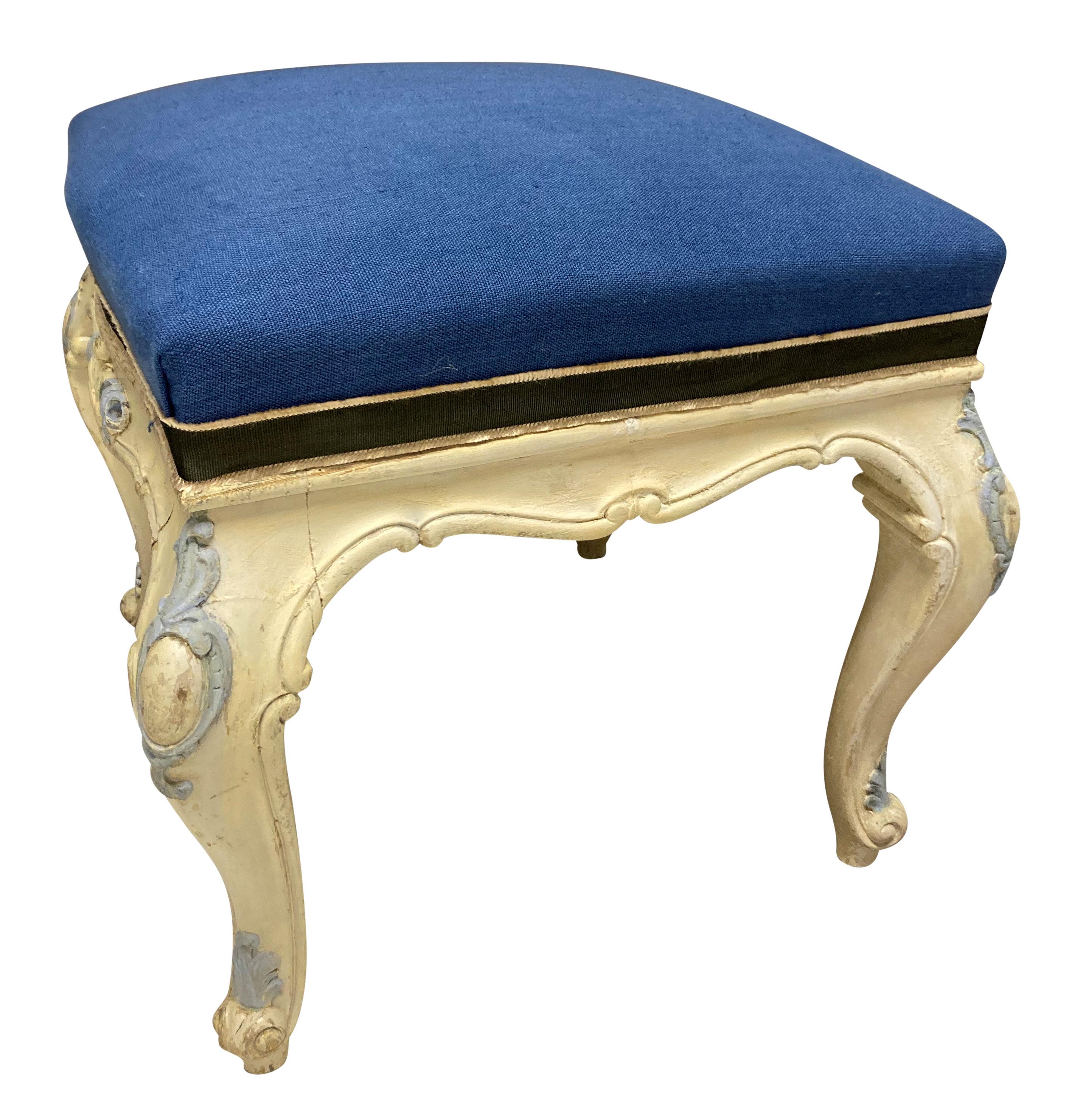 A pair of French Louis XV style carved and painted stools in very pale yellow and cornflower blue paints, newly upholstered in blue linen with sage and cream silk fringed ribbon.