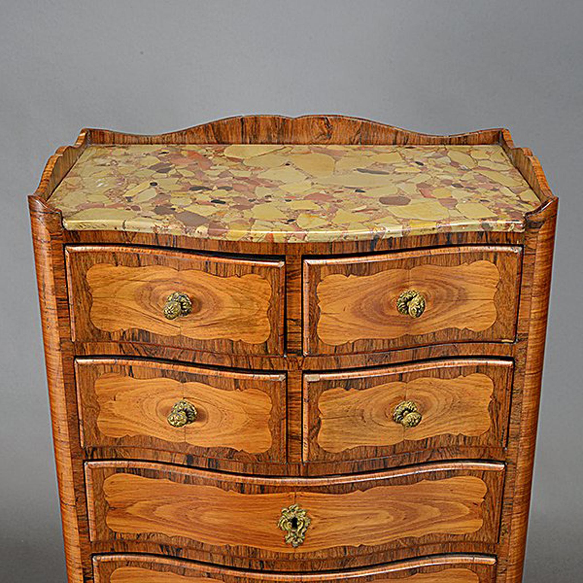 Attractive pair of 19th century French Louis XV style tall semainier chests, 19th century.
The inset mottled marble top is over an inlaid tall chest semainier with four short drawers and five long drawers mounted with bronze pulls and escutcheons,