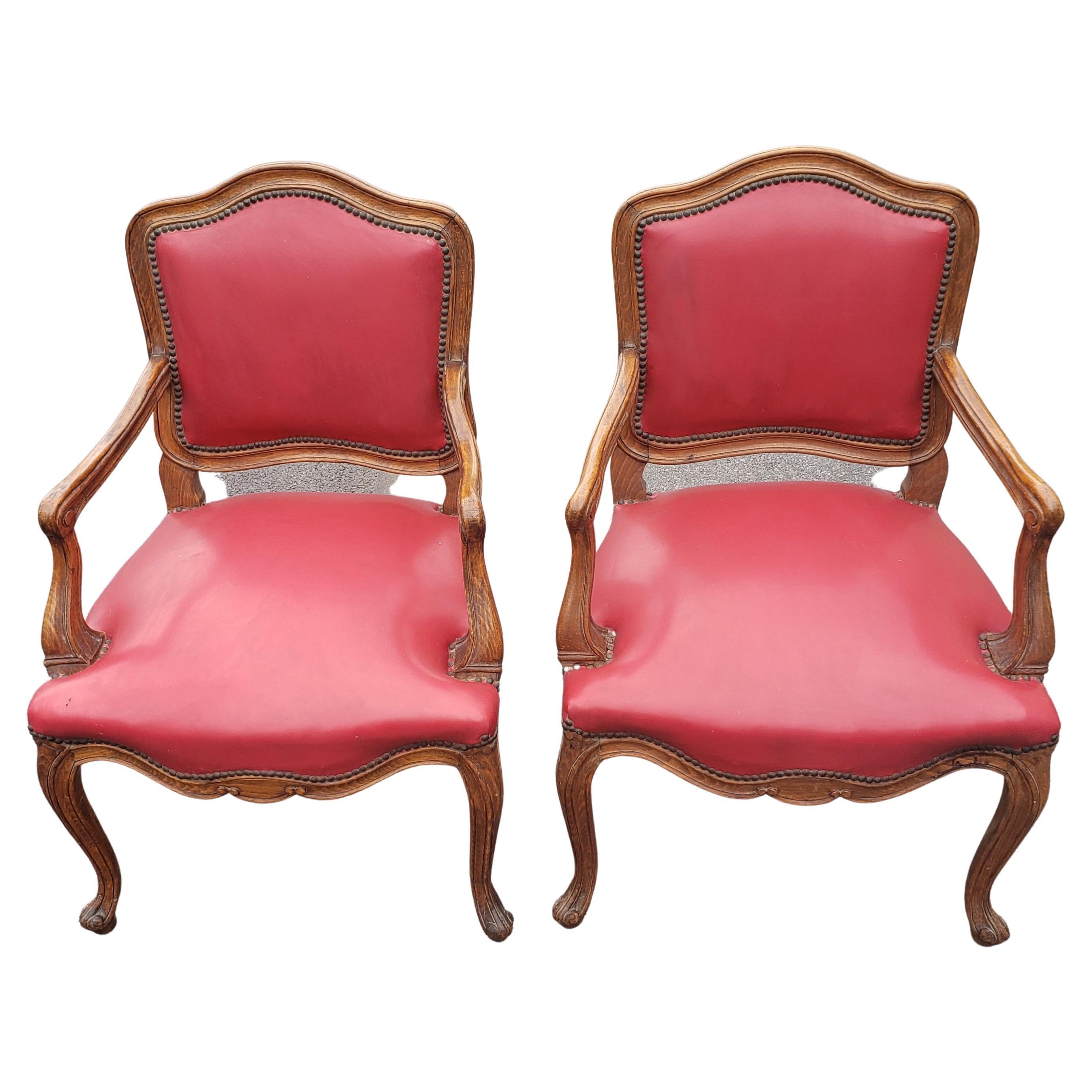 Pair of Louis XV style red leather upholstered oak fauteuils. Very good vintage condition. Webbed seat support in very good condition. Very comfortable
Measure 24.5