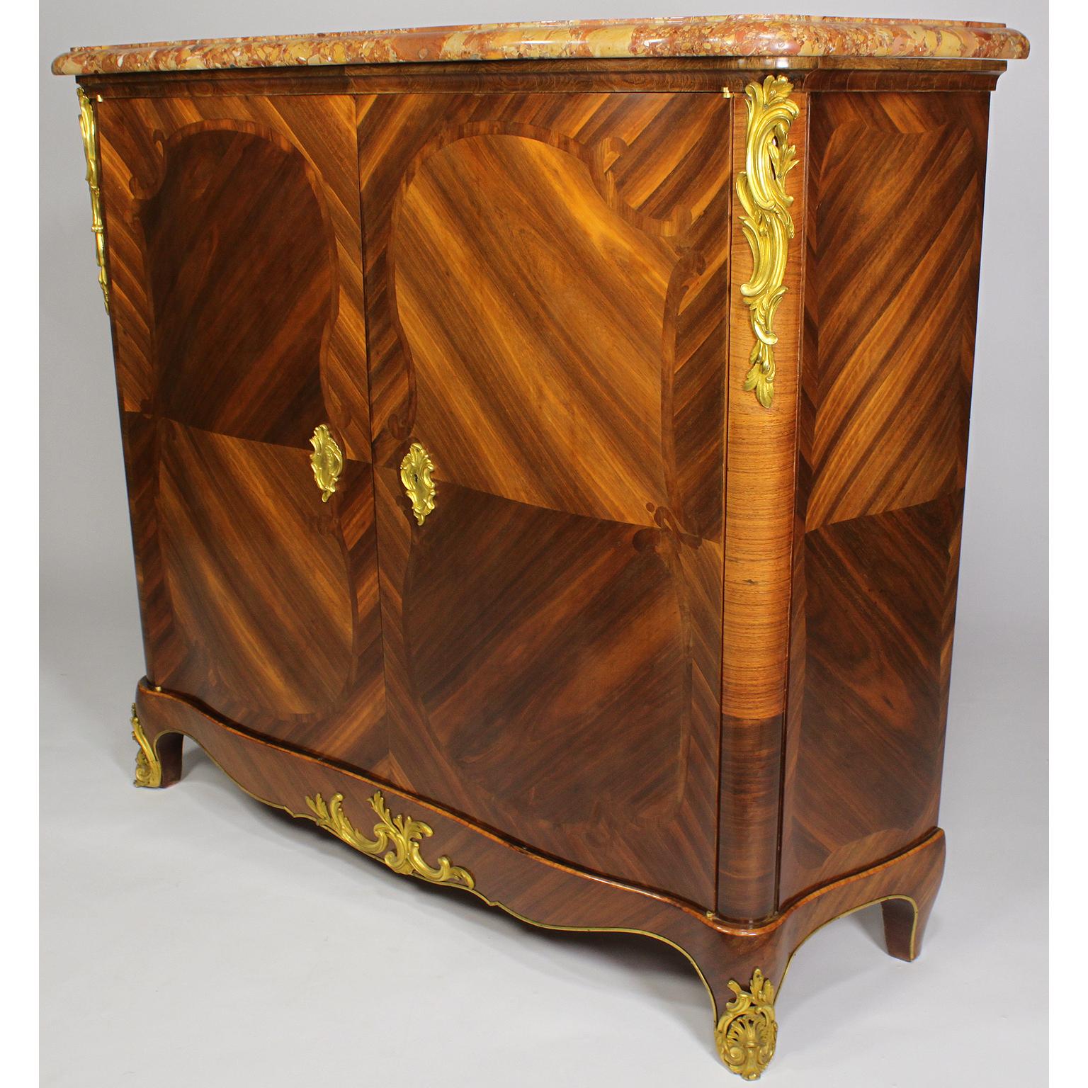 A fine pair of French 19th century Louis XV style tulipwood and gilt bronze mounted two-Door Meuble D'Appui (Side-Cabinets) with a Brêche d'Alep marble top. The slender cabinets, each with two front doors reveling a pair of indoor shelves,