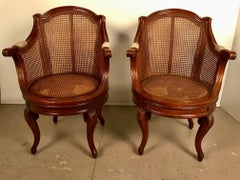 Pair of French Louis XV Style Walnut & Caned Swivel Armchairs