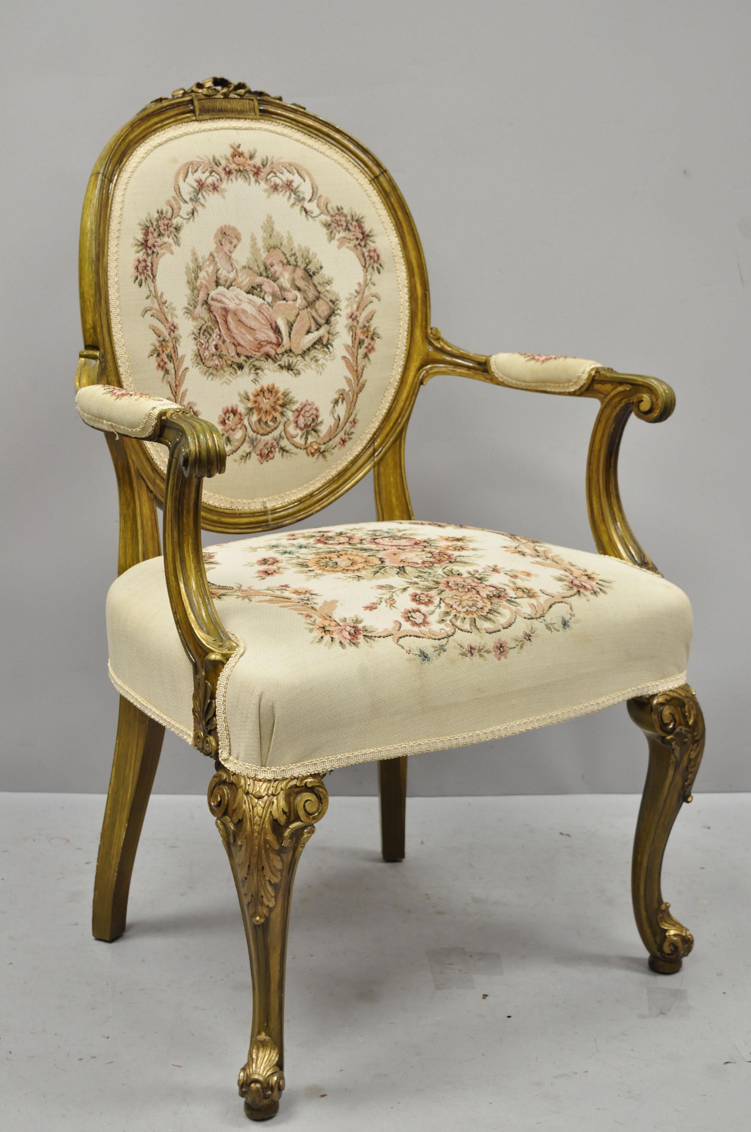 Pair of French Louis XV Victorian Style Needlepoint Tapestry Fireside Arm Chairs. Item features distressed green and gold painted finish, tapestry upholstery, figures to back, nicely carved details, cabriole legs, very nice antique item, great style
