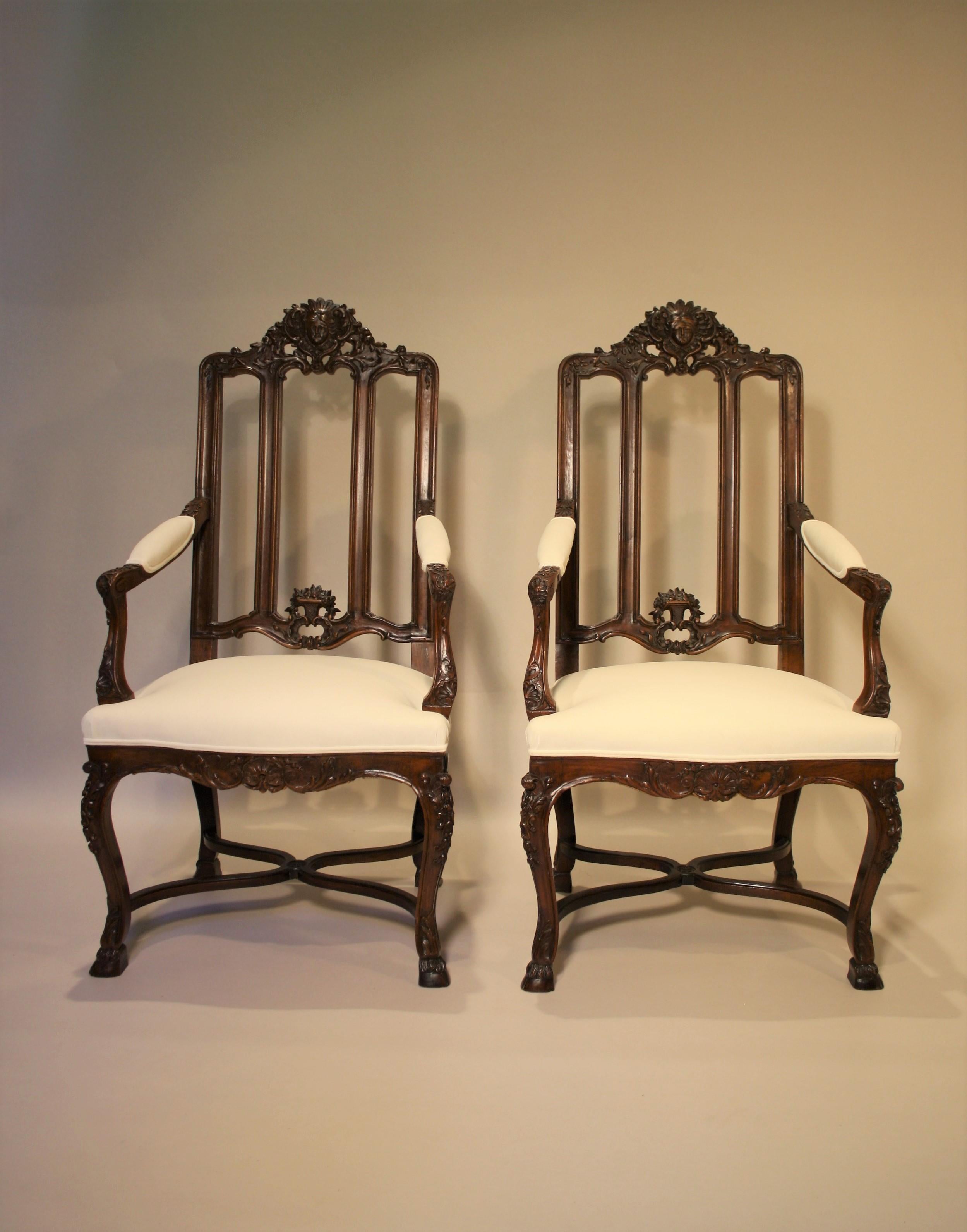 Exceptional pair of 19th century French walnut armchairs.
They are richly sculpted with acanthus leaves, shells, and a head of a goddess.
These chairs were made in a Parisian Workshop and come from the Castle of Fanson in the Belgian Ardennes (About