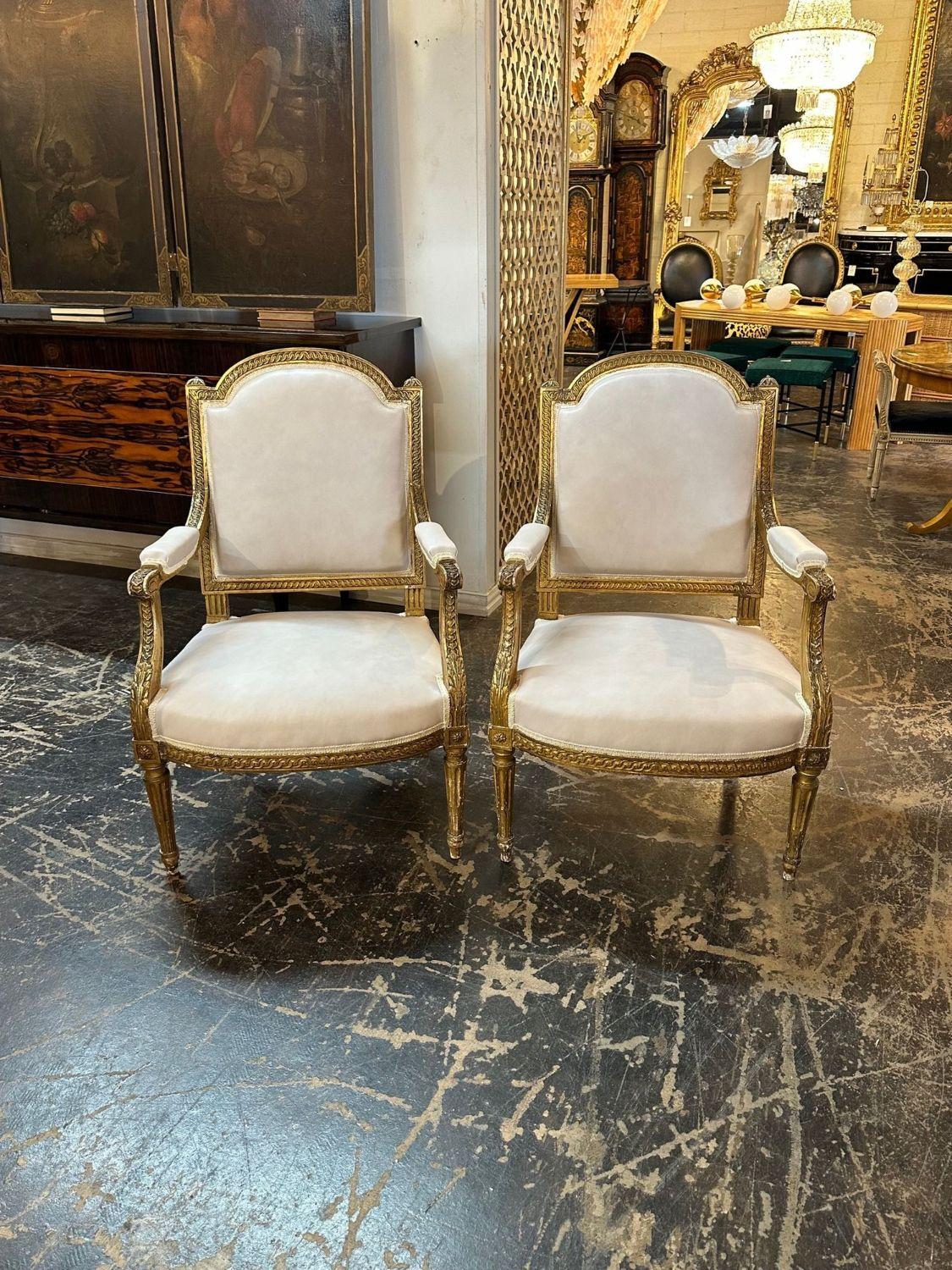 French Louis XVI carved and giltwood armchairs with leather upholstery. circa 1870. Perfect for today's transitional designs! Sold by the pair.
