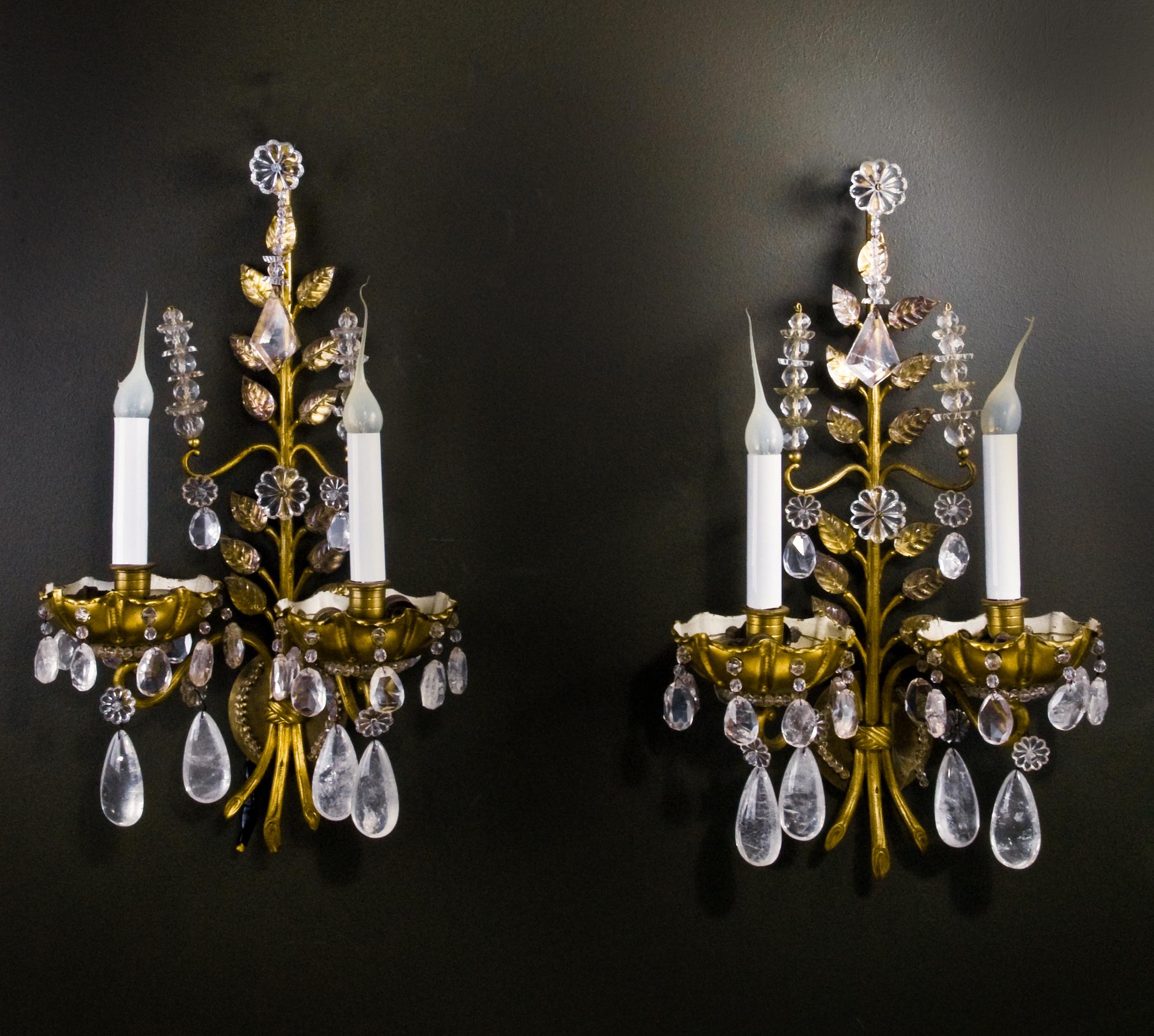 A pair of fine French Louis XVI Baguès style rock crystal, glass and gilt bronze double light wall sconces embellished with rock crystal prisms, glass beads and glass leaves.